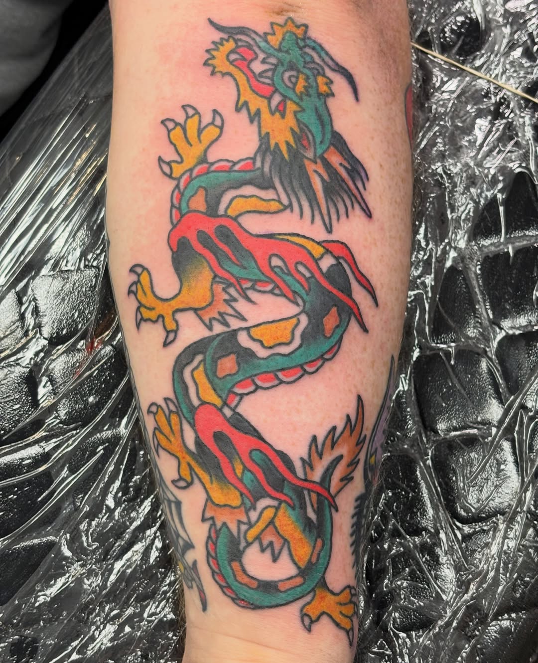 Dragon American traditional tattoo on the forearm by Natalie Opal🪻🍎🫖
