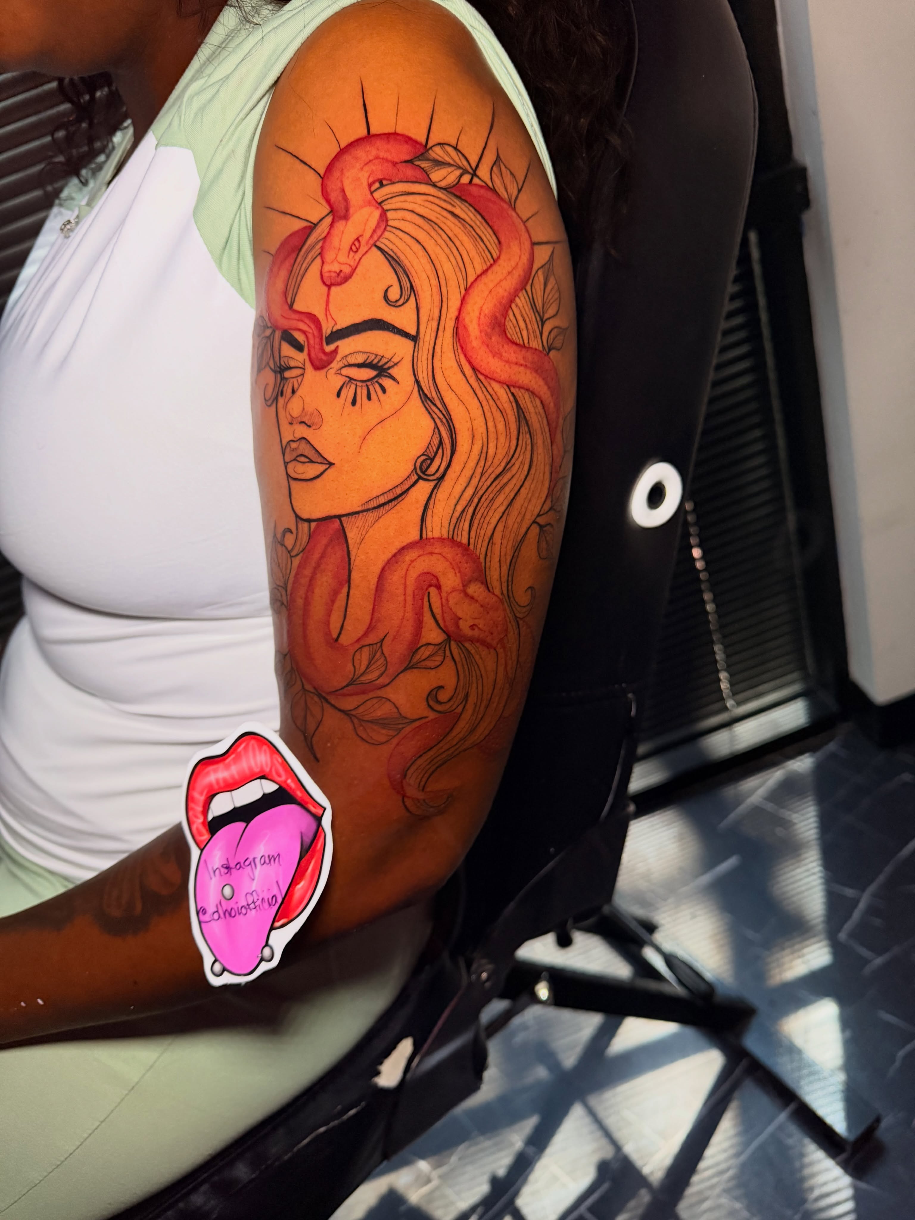 Woman with snakes illustrative tattoo on the upper arm by Doll The Tattoo Artist, Addison, Texas