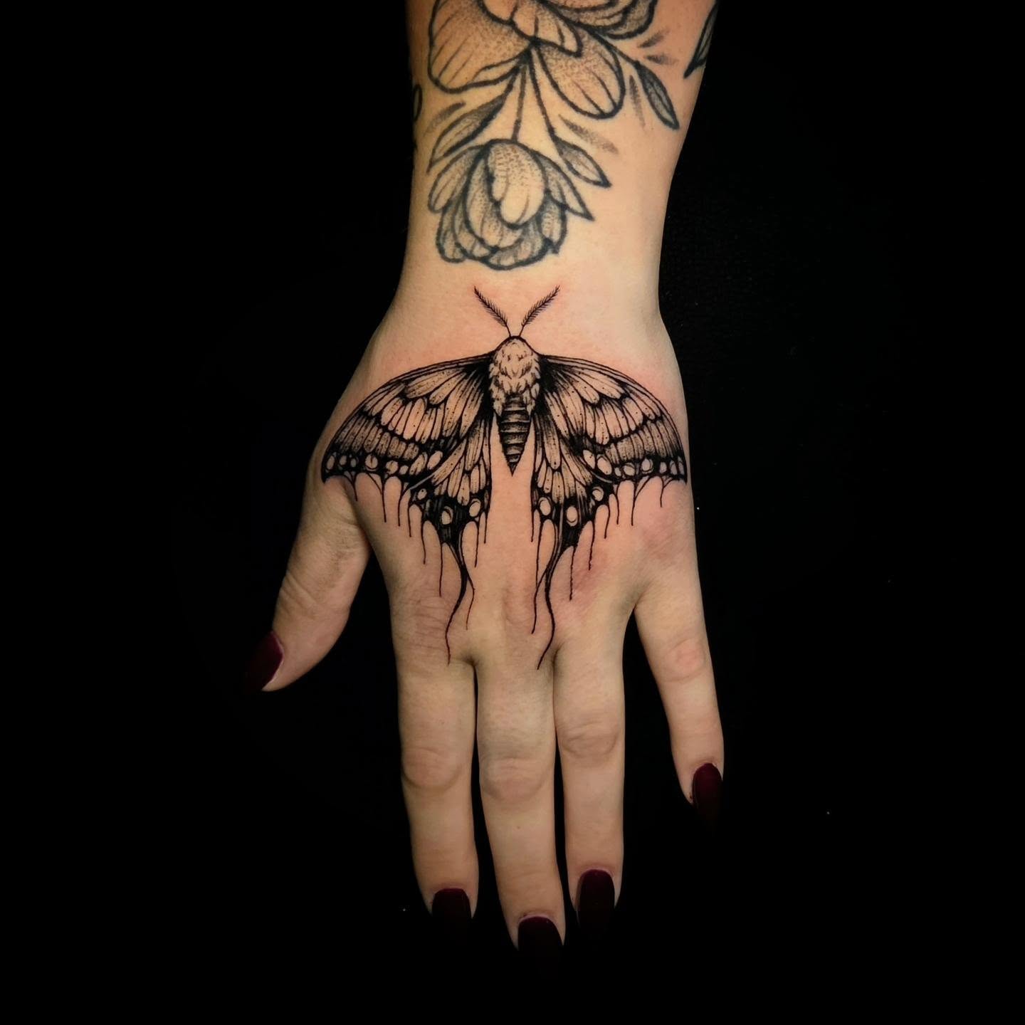 Moth black and grey tattoo on the hand by Nick de Hoyos