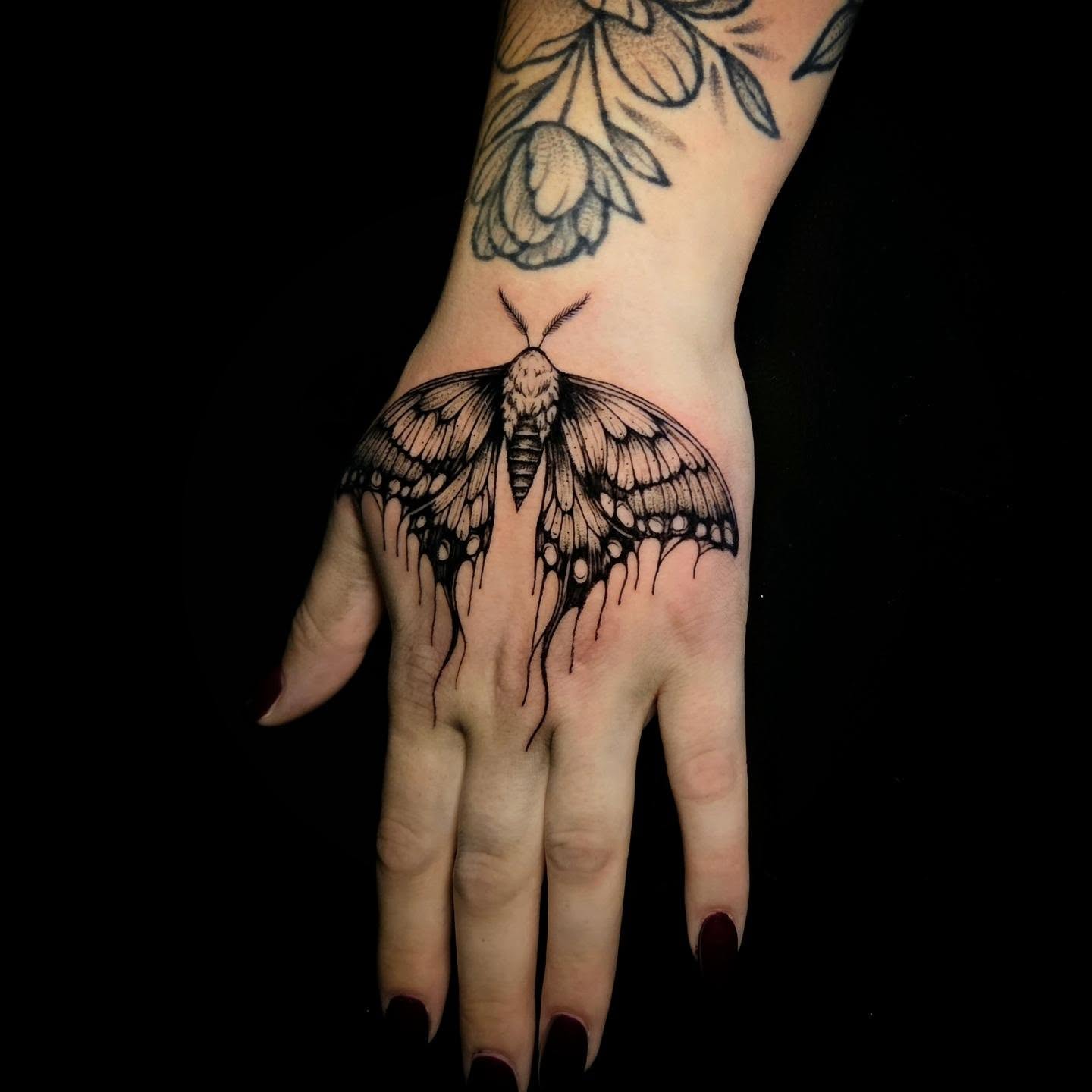 Moth black and grey tattoo on the hand by Nick de Hoyos