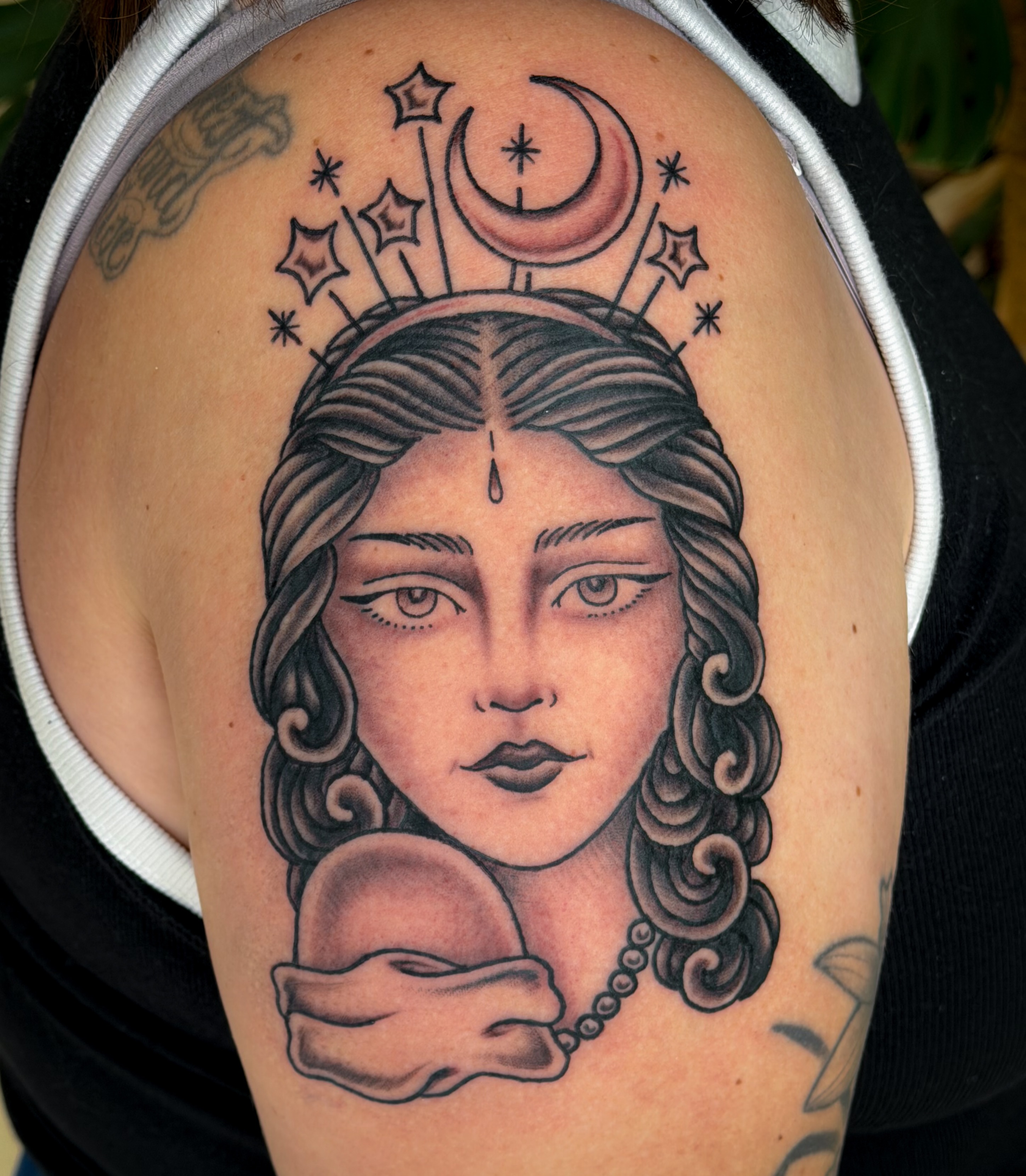 Woman with crescent moon and stars realism tattoo on the shoulder by Jessica Oram Brockman, Dayton, Ohio