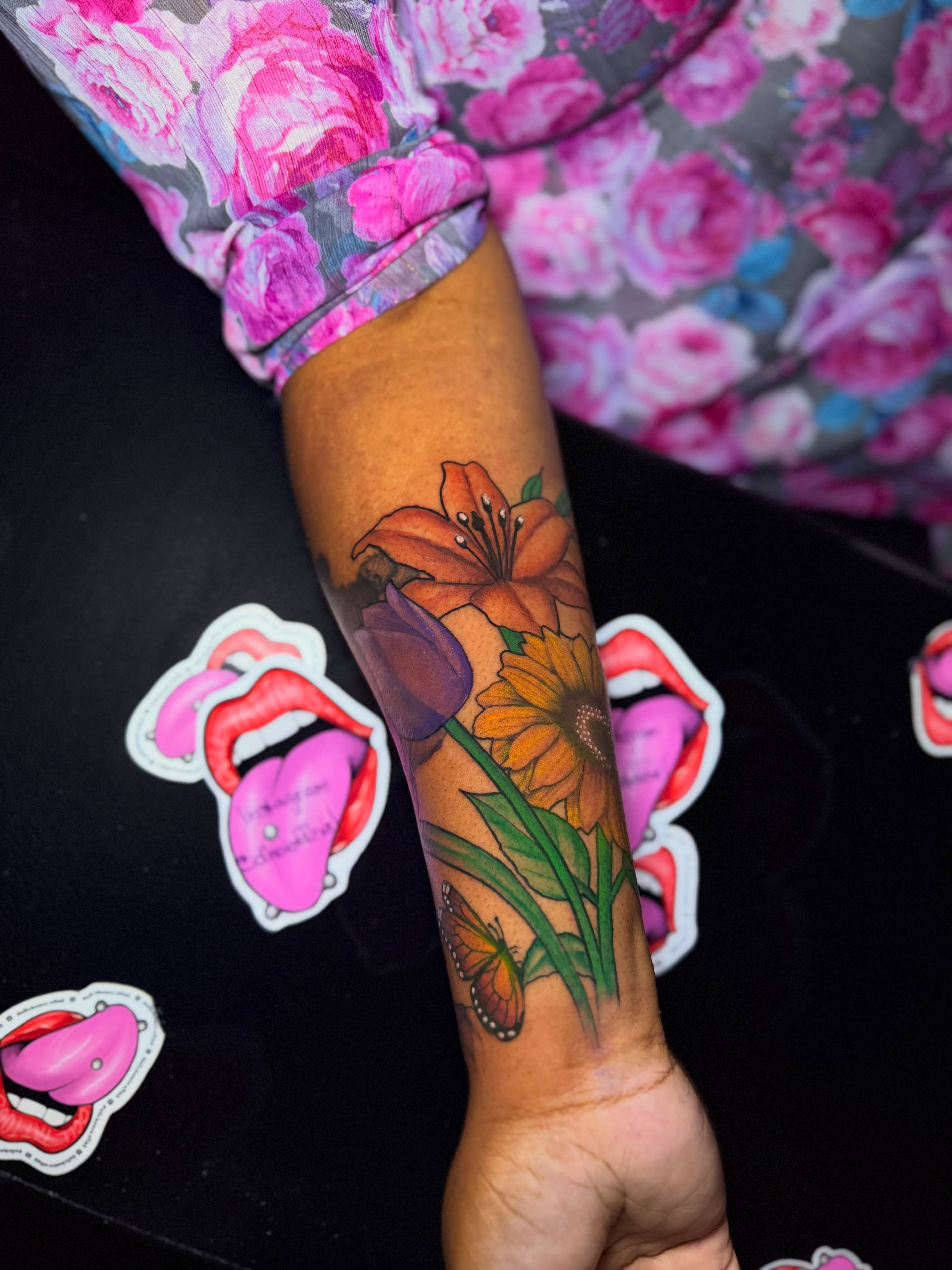 Flowers and butterfly watercolor tattoo on the forearm by Doll The Tattoo Artist, Addison, Texas