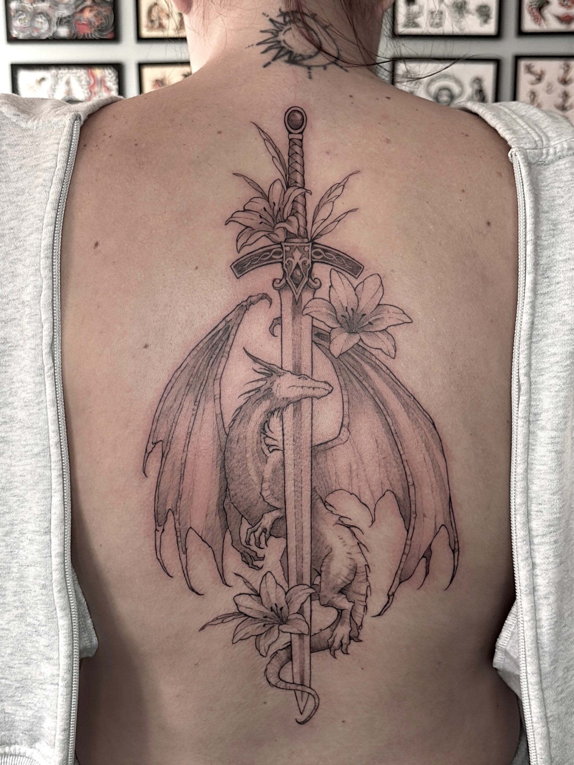 Dragon and sword realism tattoo on the back by Harlee Hornsby