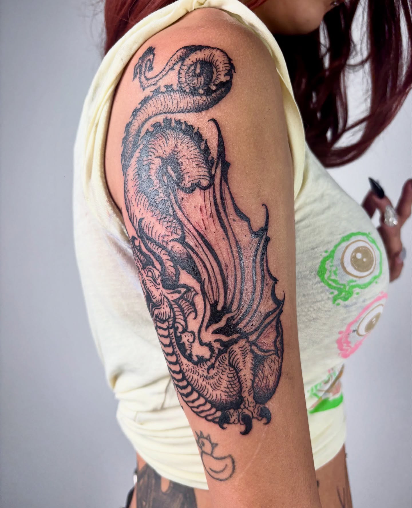 Octopus black and grey tattoo on the upper arm by kendle