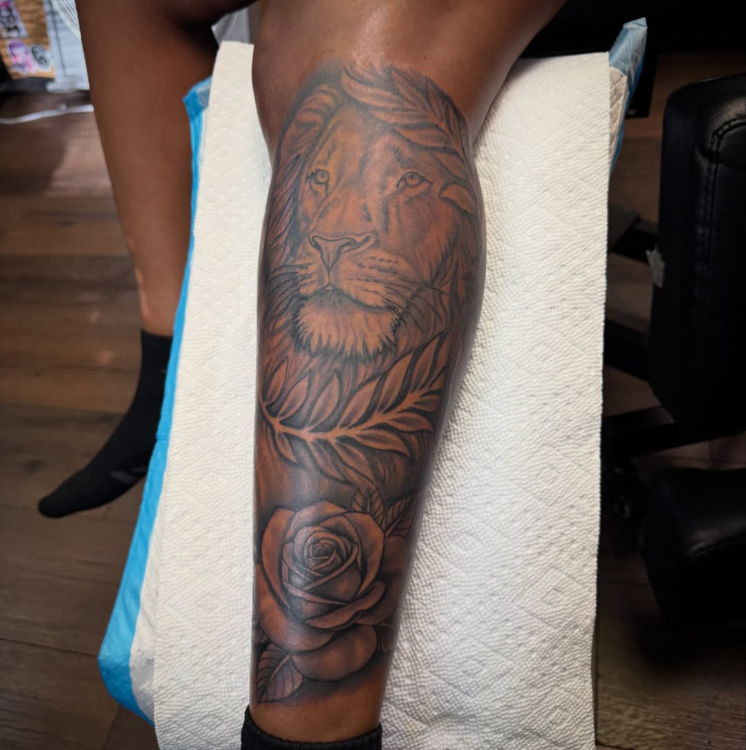 Lion and rose realism tattoo on the forearm by Christian Goines, Memphis, Tennessee