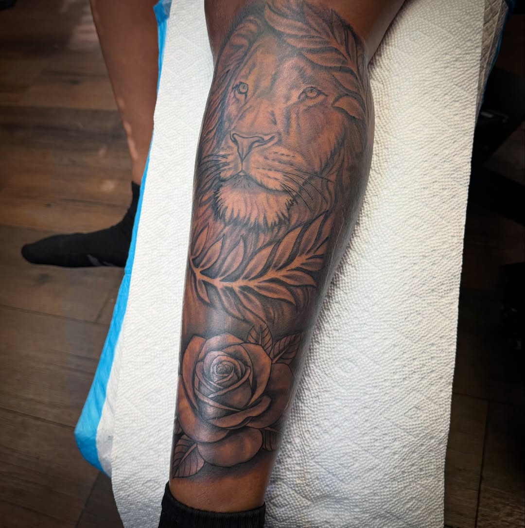 Lion and rose realism tattoo on the forearm by Christian Goines, Memphis, Tennessee