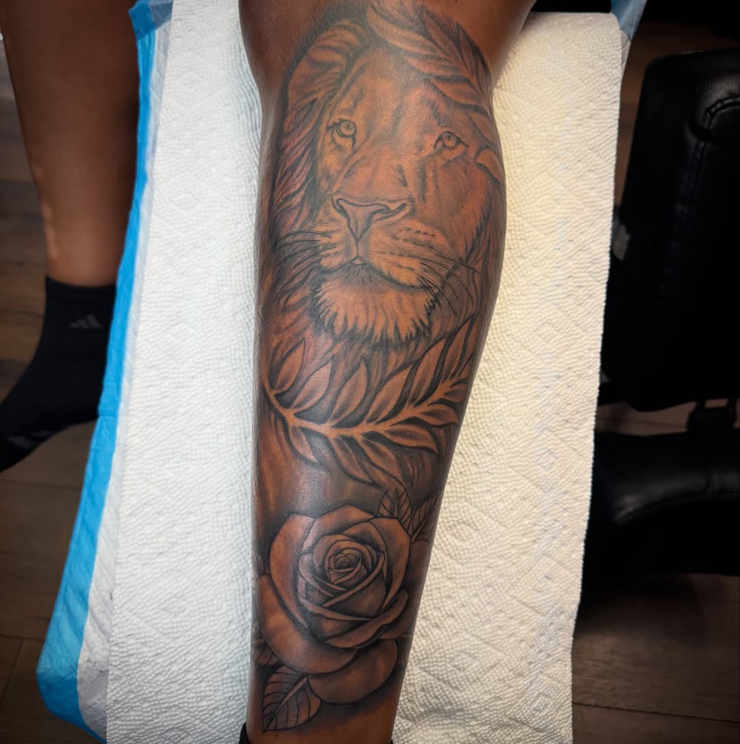 Lion and rose realism tattoo on the forearm by Christian Goines, Memphis, Tennessee