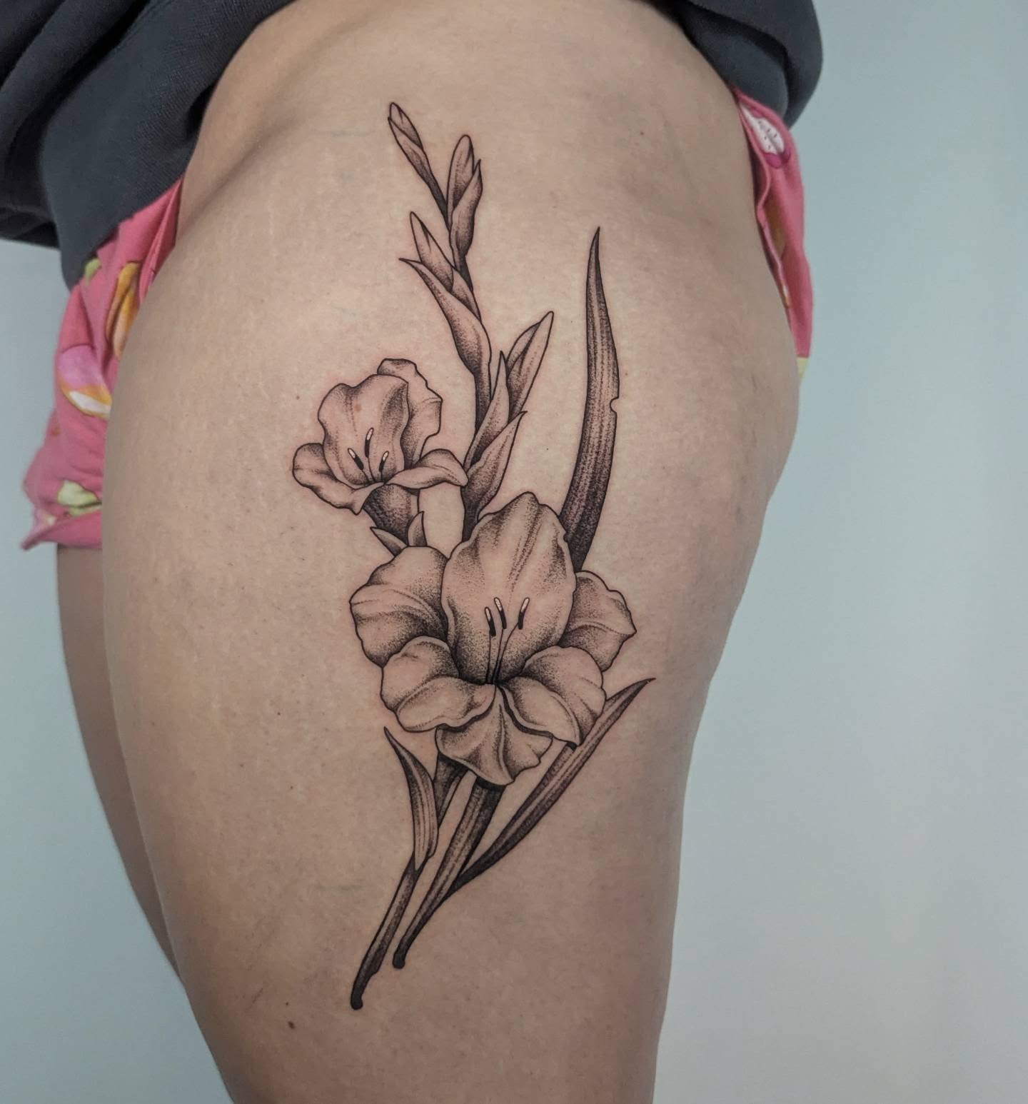 Gladiolus flowers dotwork tattoo on the thigh by Courtney Yaddof