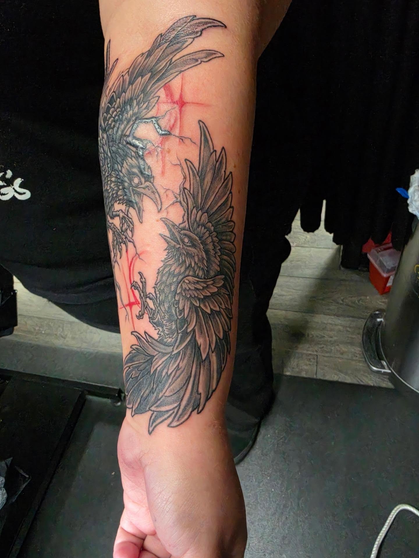 Raven black and grey tattoo on the forearm by Dark Luna Tattoos LLC