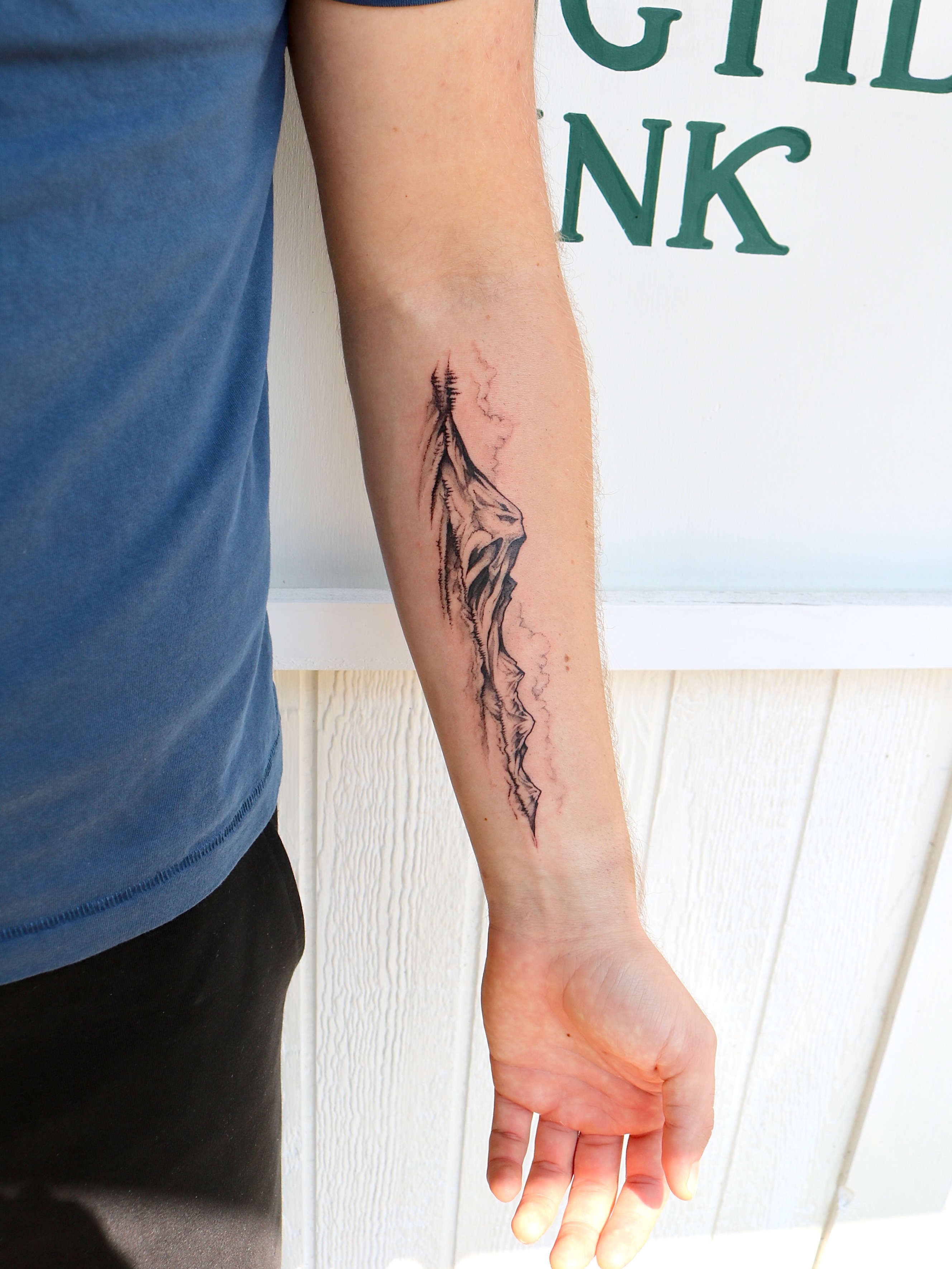 Abstract rock formation black and grey tattoo on the forearm by Kingtide Ink
