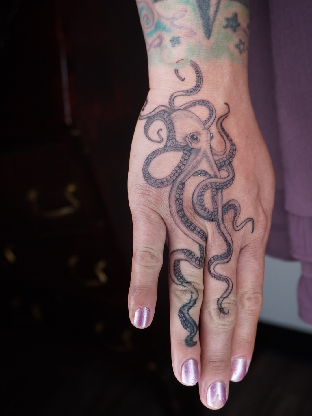 Octopus black and grey tattoo on the hand by Ashley Limon