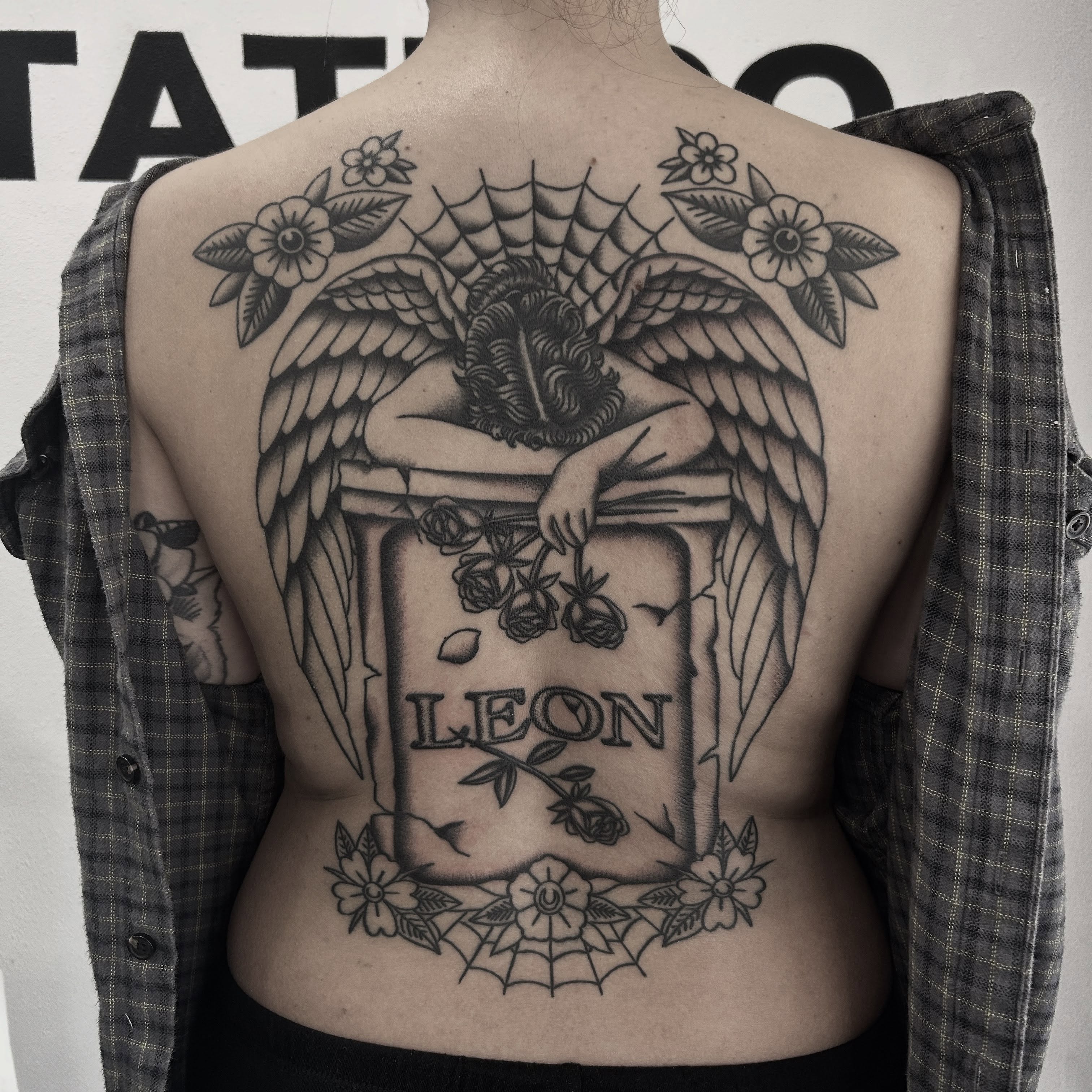 Angel with roses American traditional tattoo on the back by Stephen Sanchez
