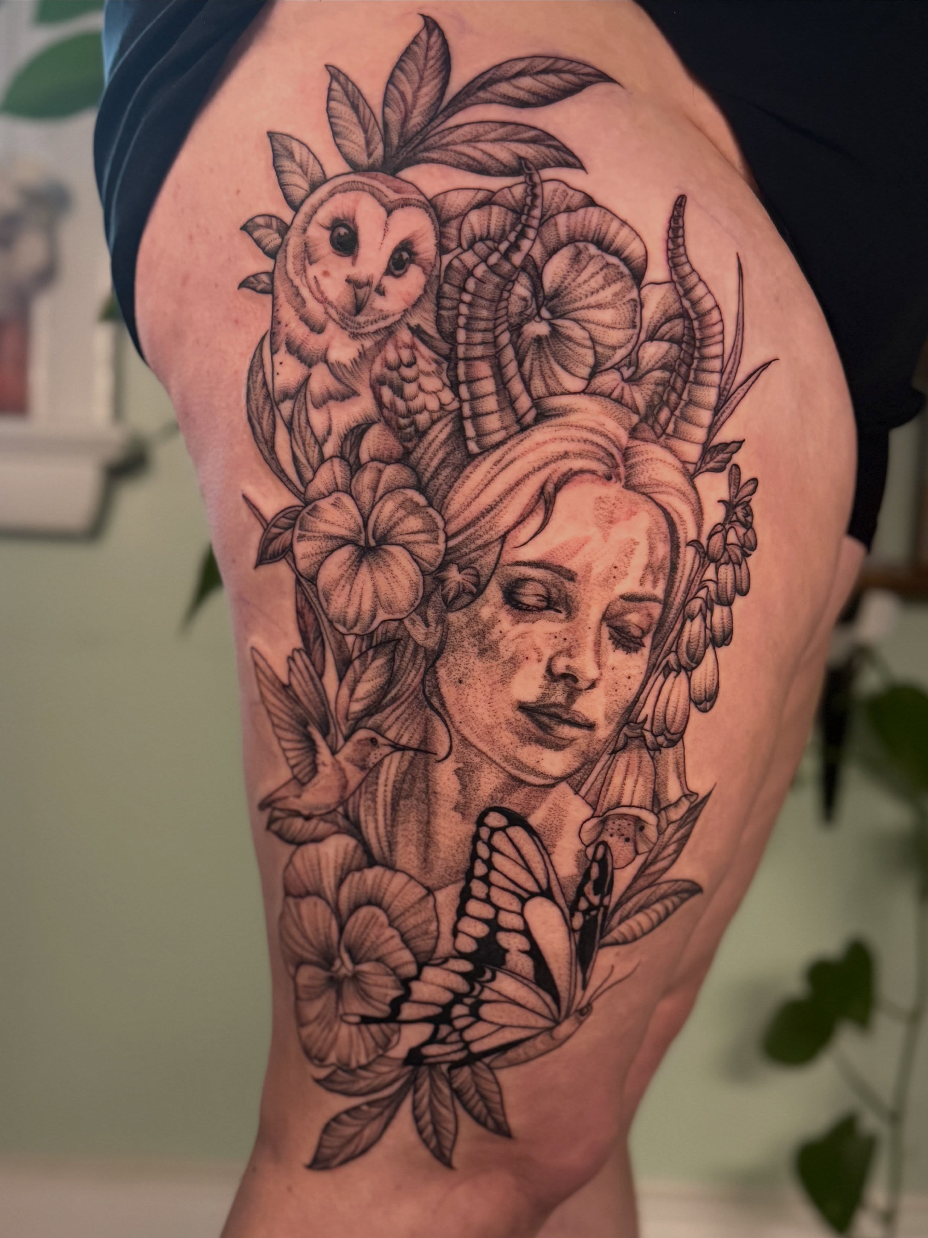 Woman with owl and butterfly dotwork tattoo on the thigh by Liz Aulenbacher