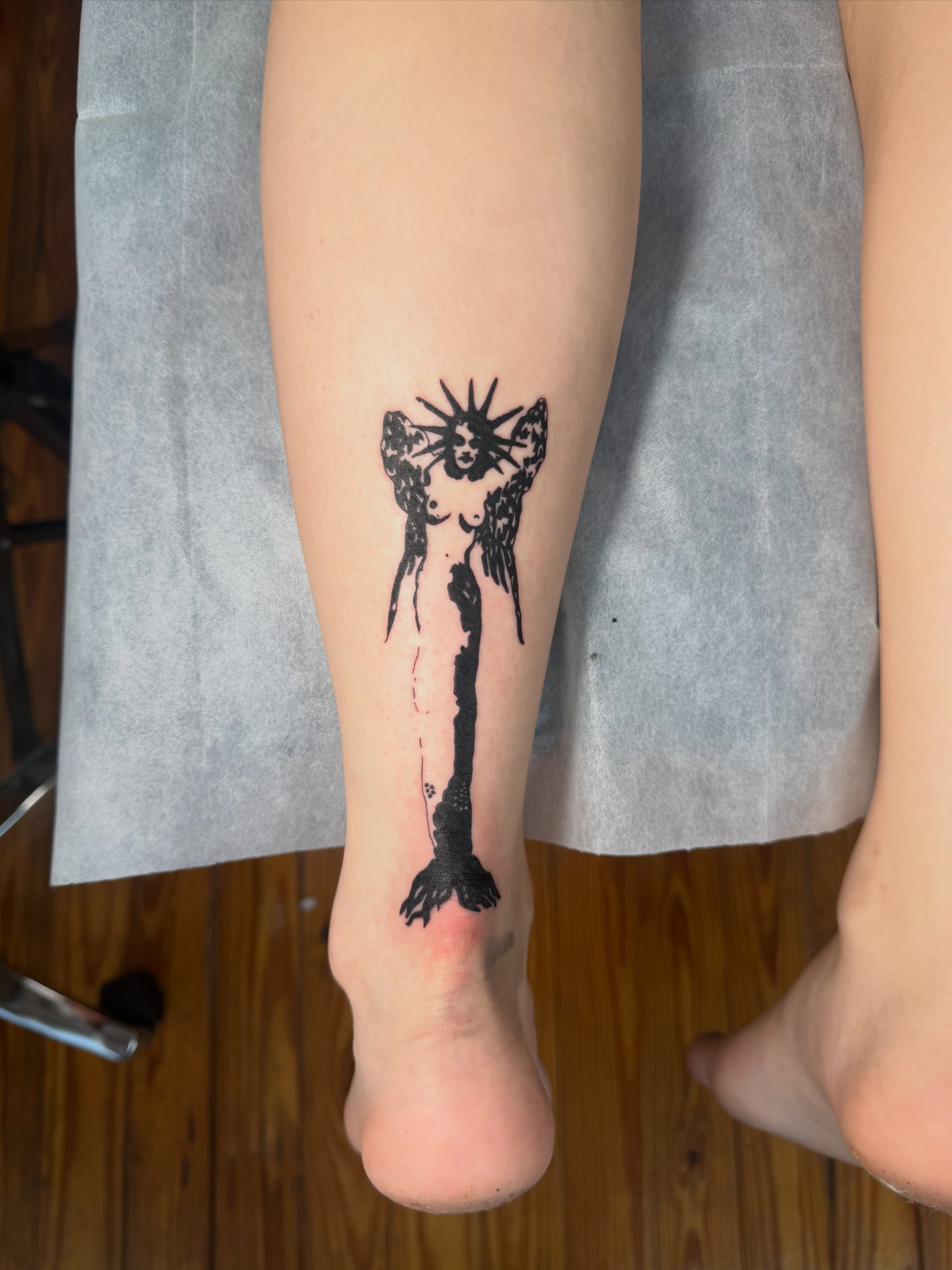 Angel black and grey tattoo on the calf by Jose Javier