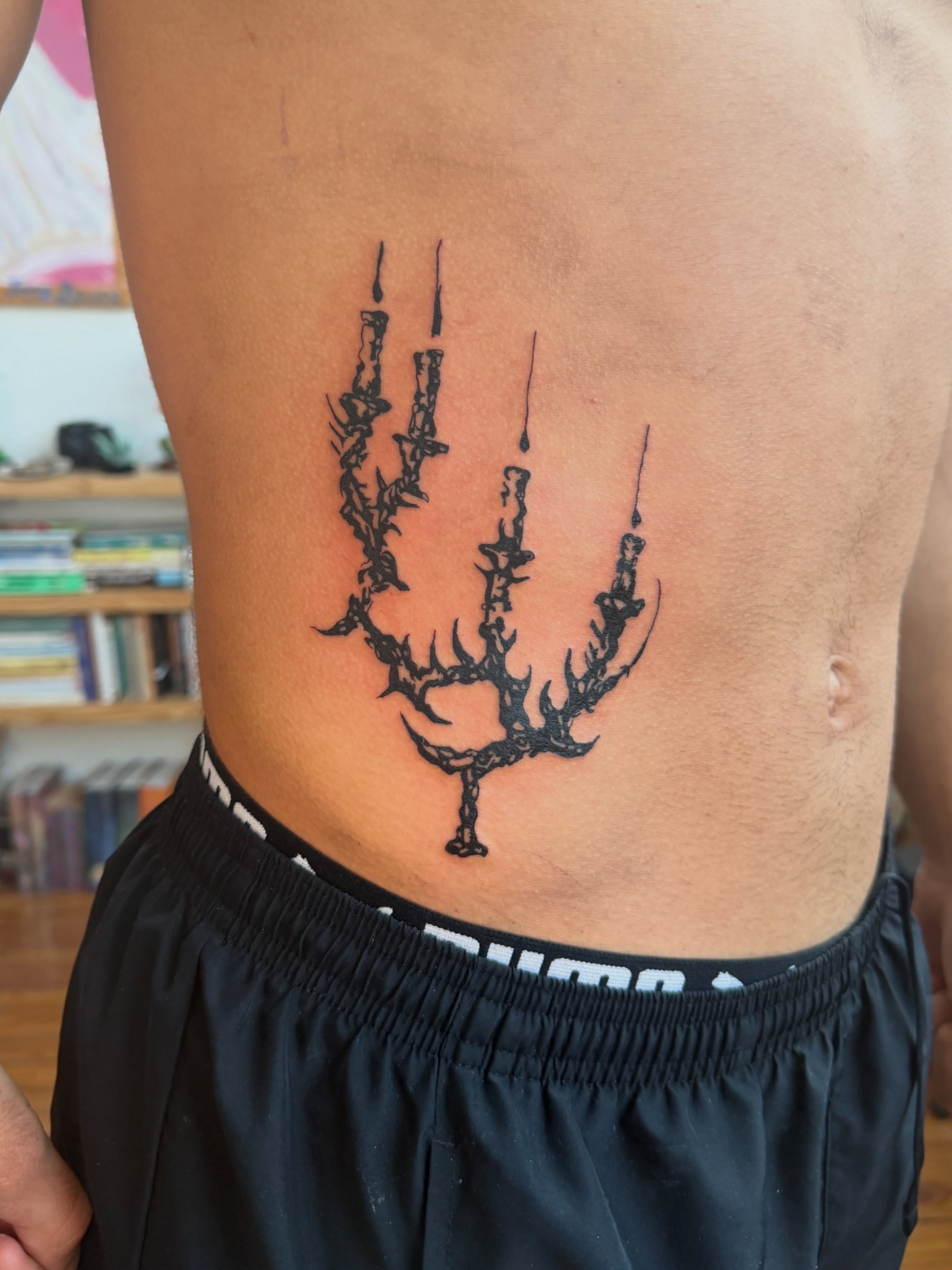 Candle arrangement black and grey tattoo on the ribs by Jose Javier