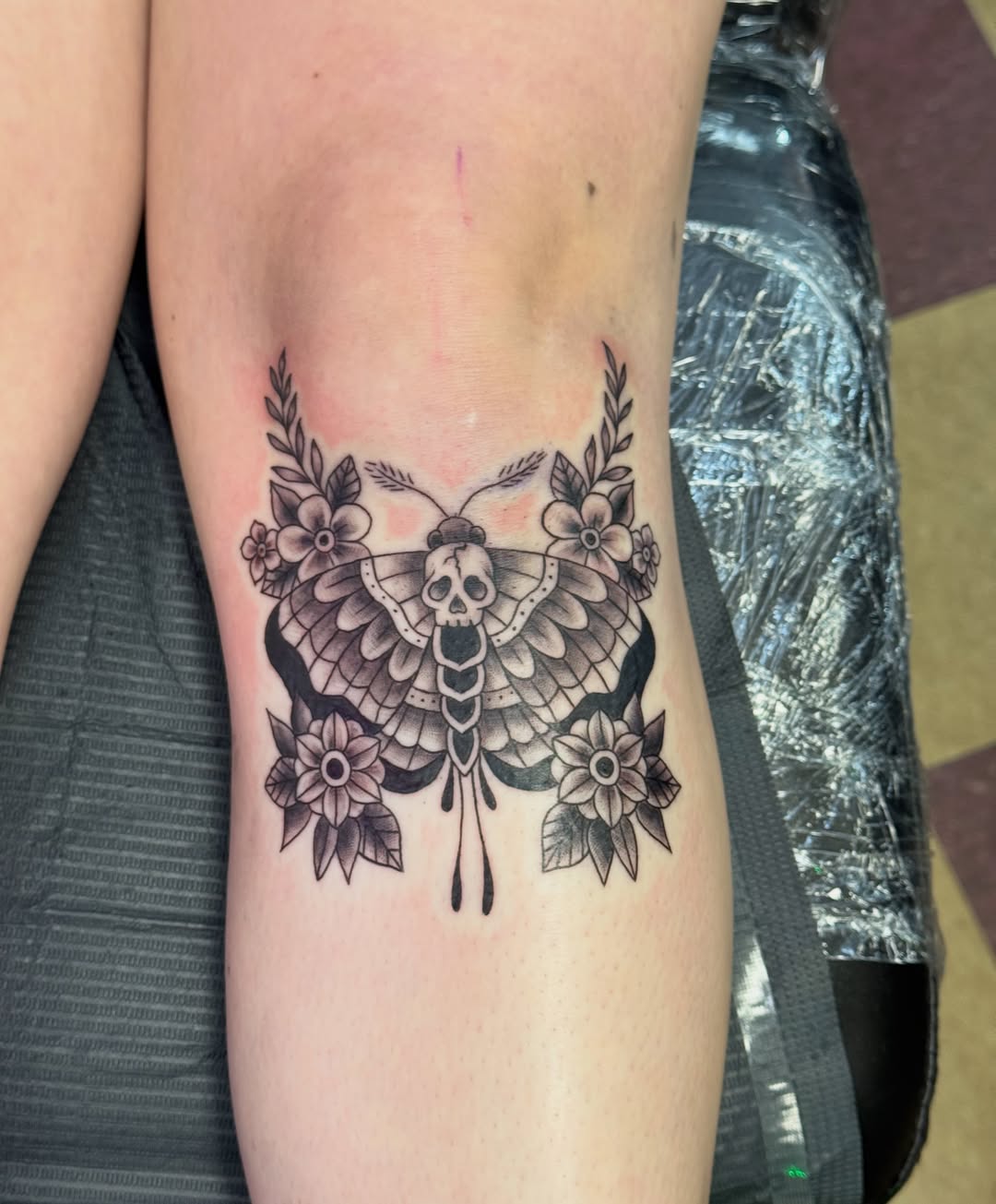 Butterfly black and grey tattoo on the forearm by Cora Phelps