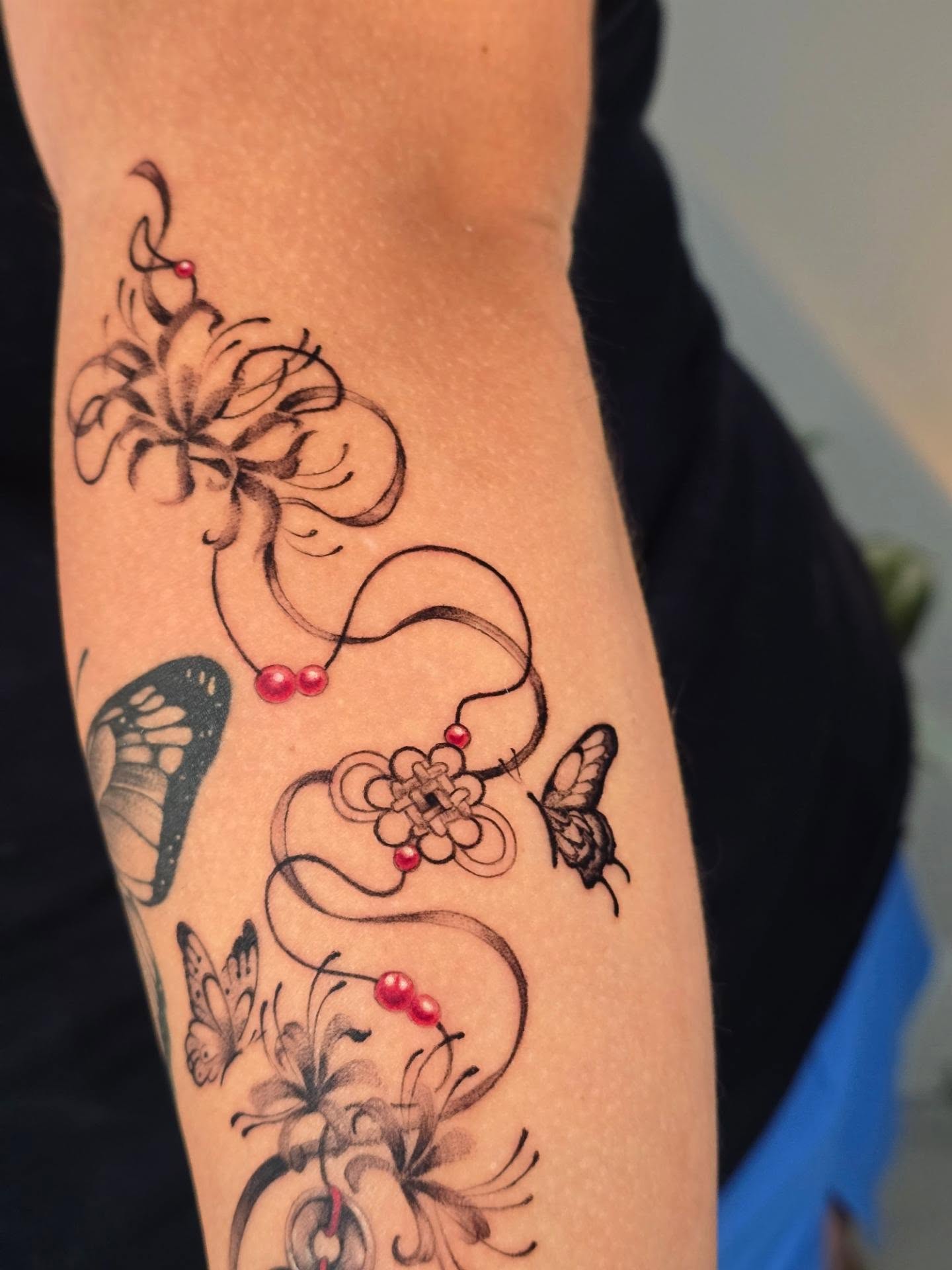 Floral and butterfly design black and grey tattoo on the forearm by Scribbles (Teala René), Charlotte, North Carolina