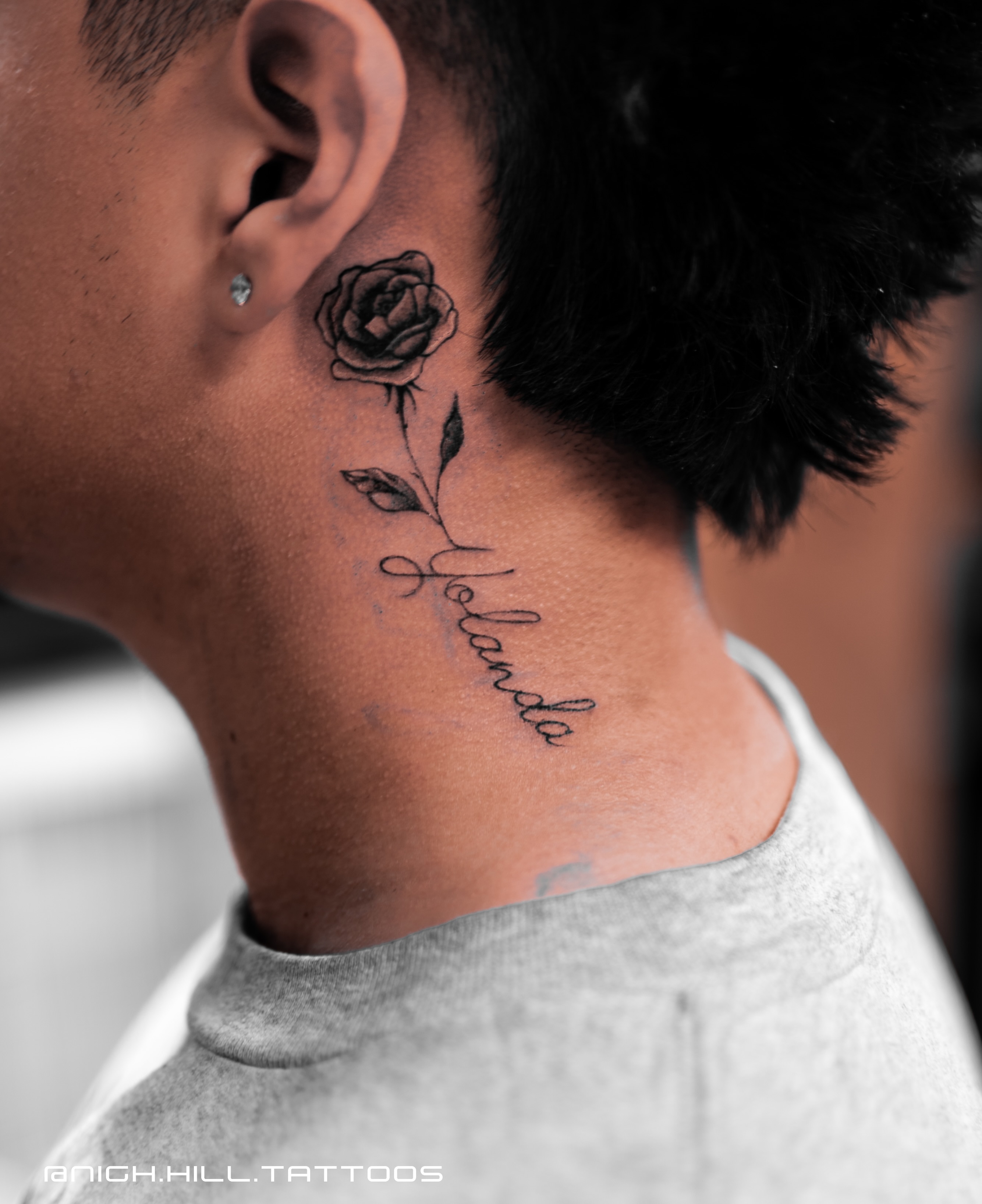 Rose and name black and grey tattoo on the neck by Boise Tattoo Artist