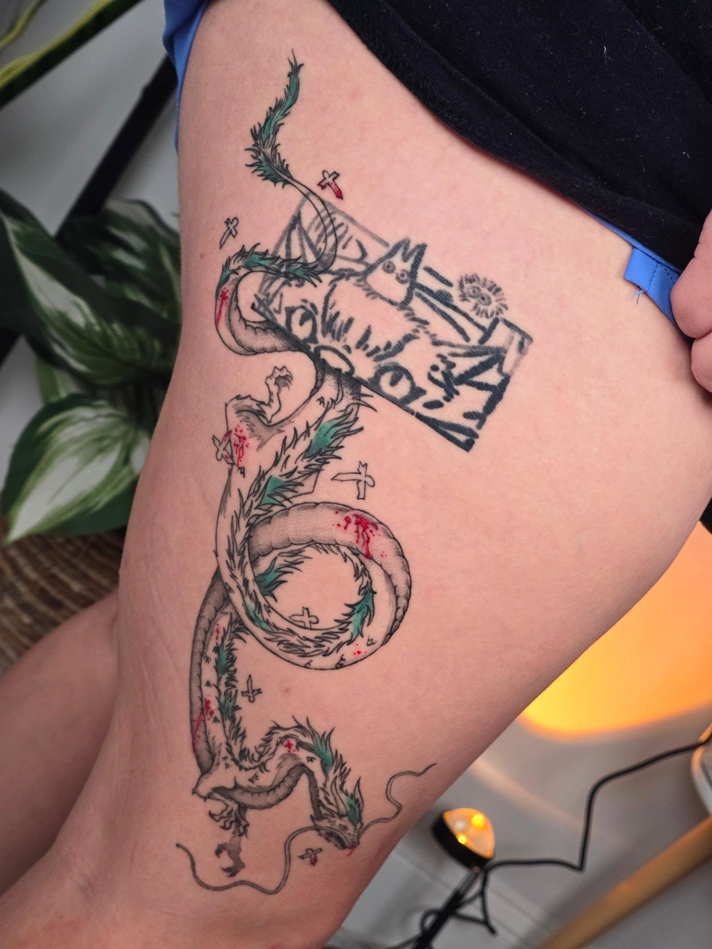 Dragon and book American traditional tattoo on the thigh by Scribbles (Teala René), Charlotte, North Carolina