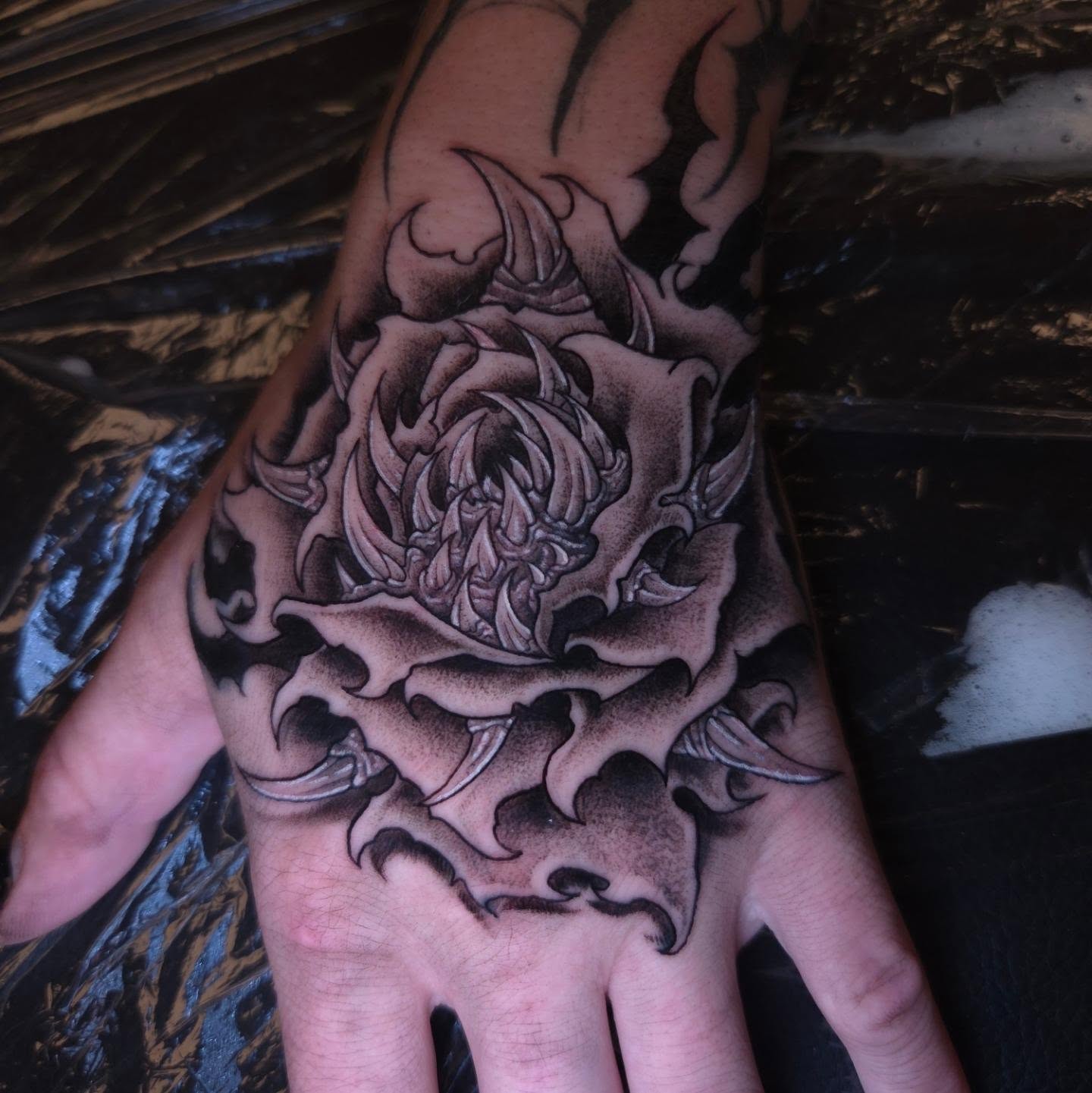 Rose black and grey tattoo on the hand by Devan Vankirk