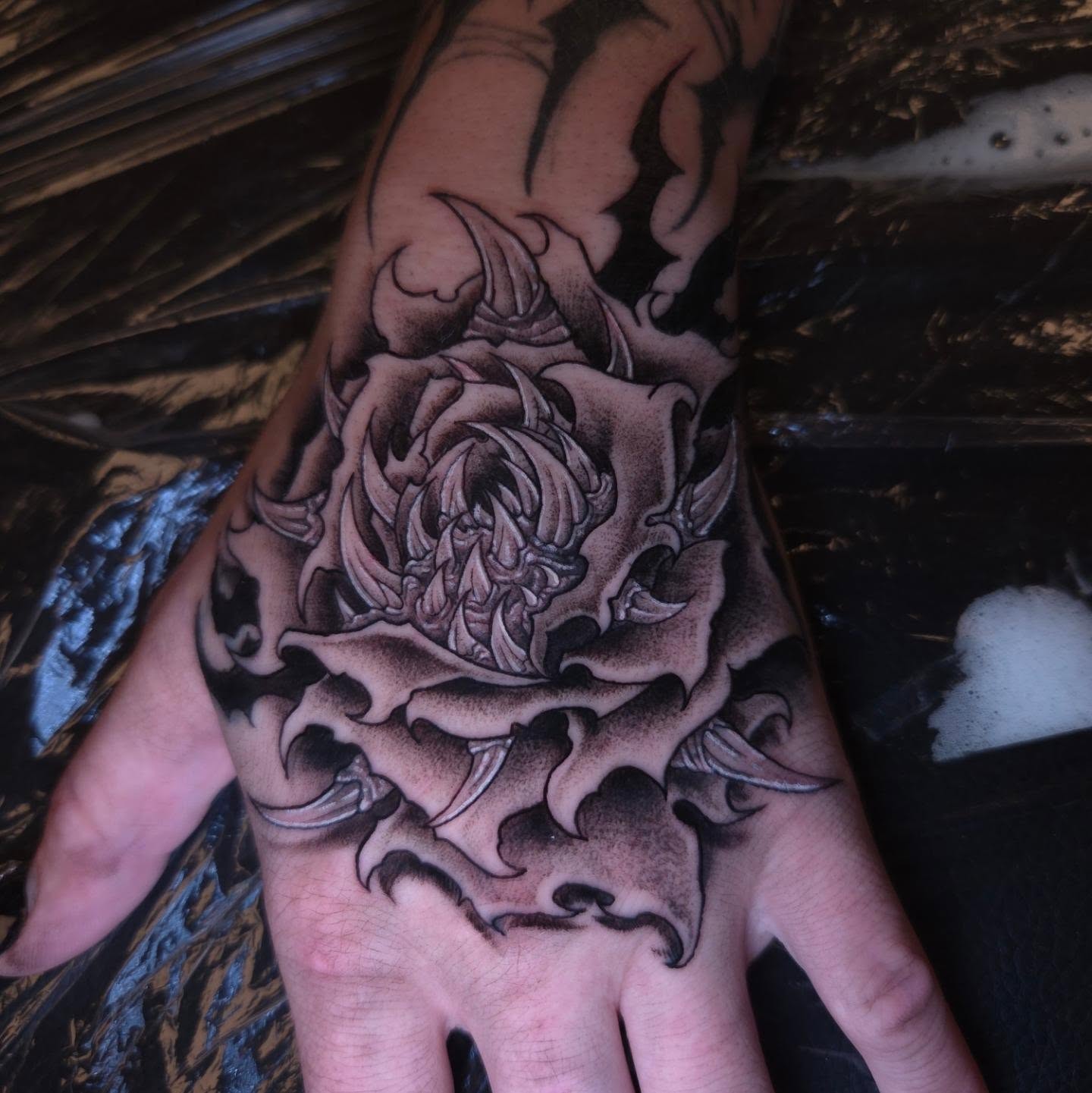 Rose black and grey tattoo on the hand by Devan Vankirk
