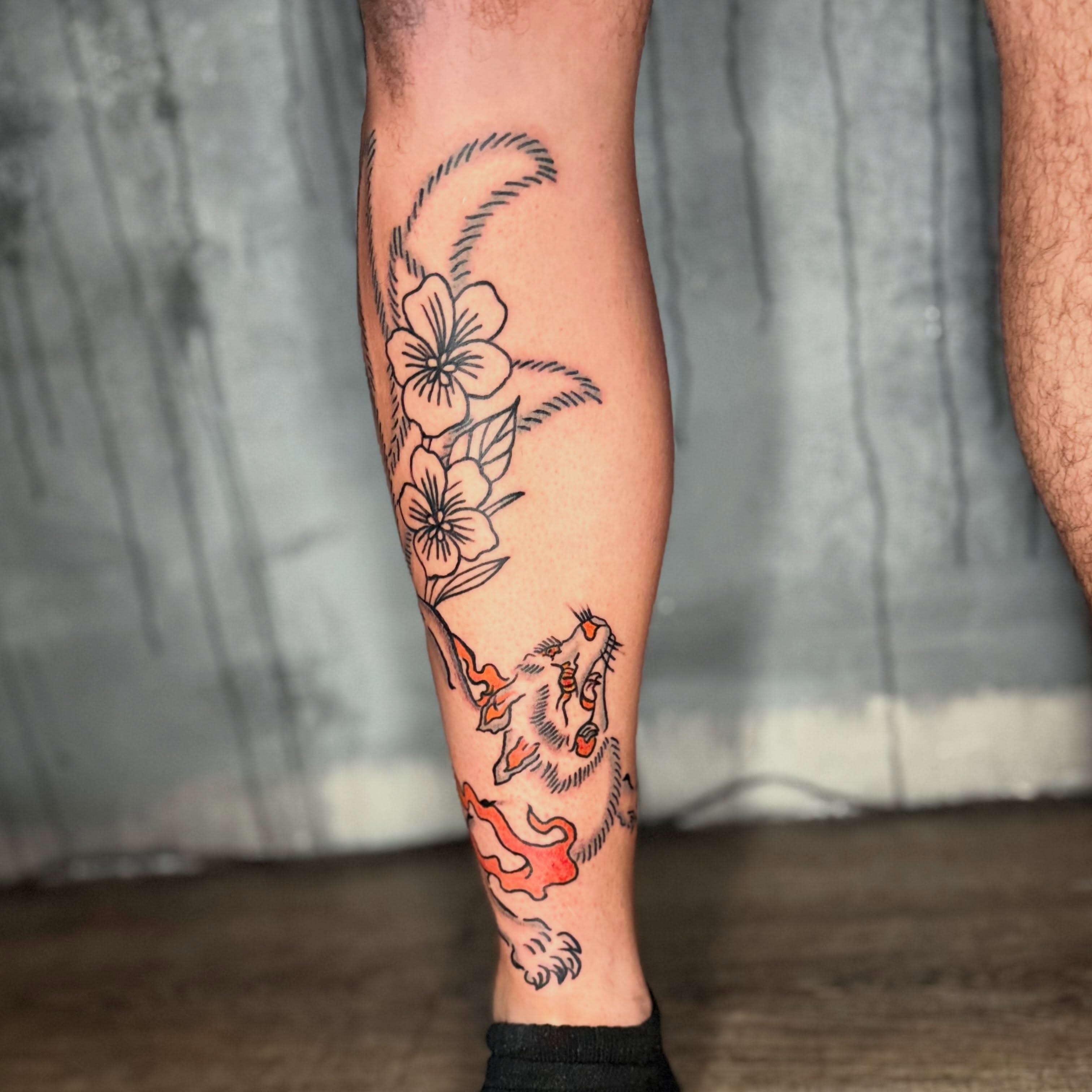 Dog and flowers American traditional tattoo on the forearm by Camilo