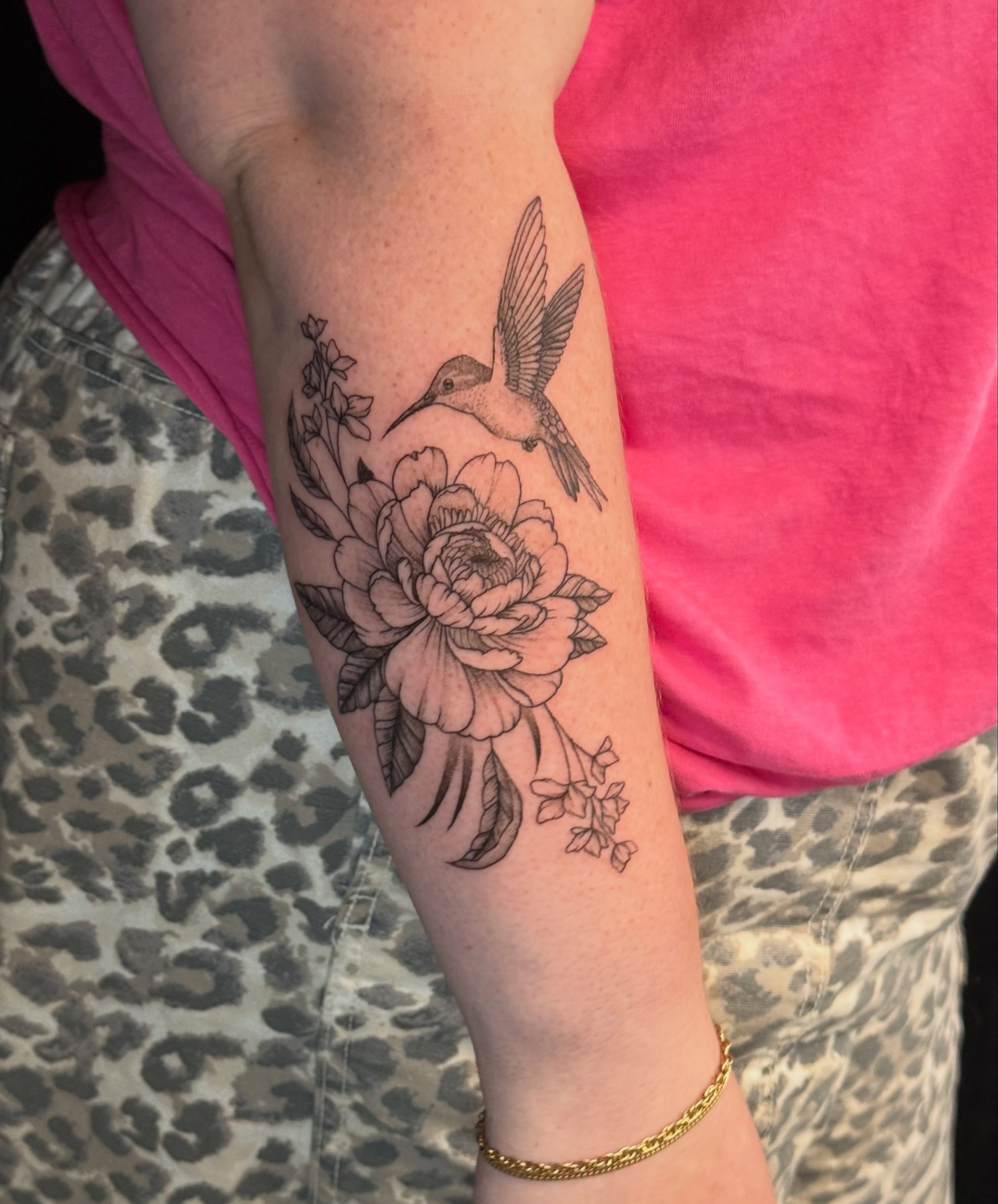 Hummingbird and flower realism tattoo on the forearm by Olivia, Royal Oak, Michigan