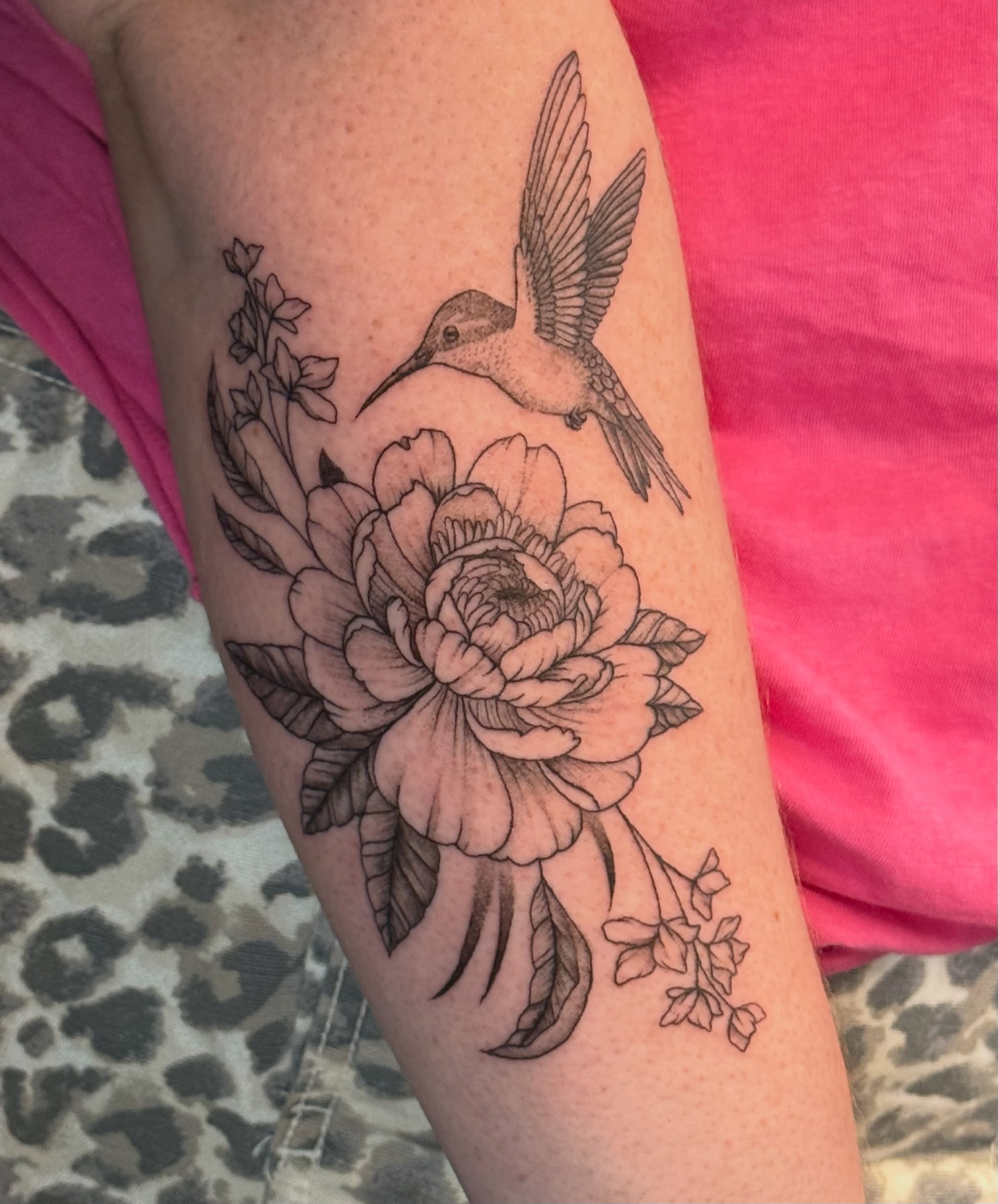 Hummingbird and flower realism tattoo on the forearm by Olivia, Royal Oak, Michigan