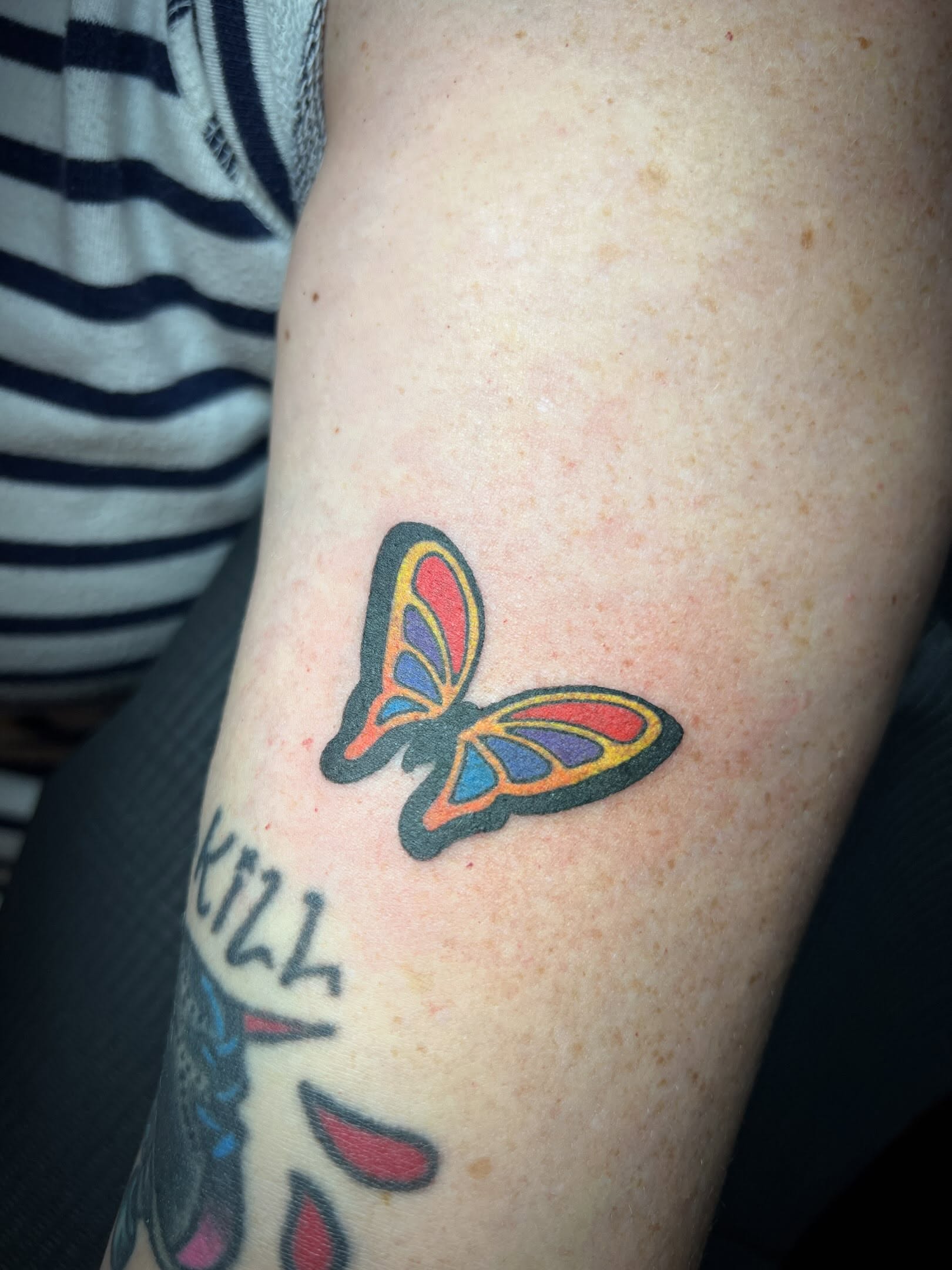 Butterfly American traditional tattoo on the forearm by Tattoo Kayla