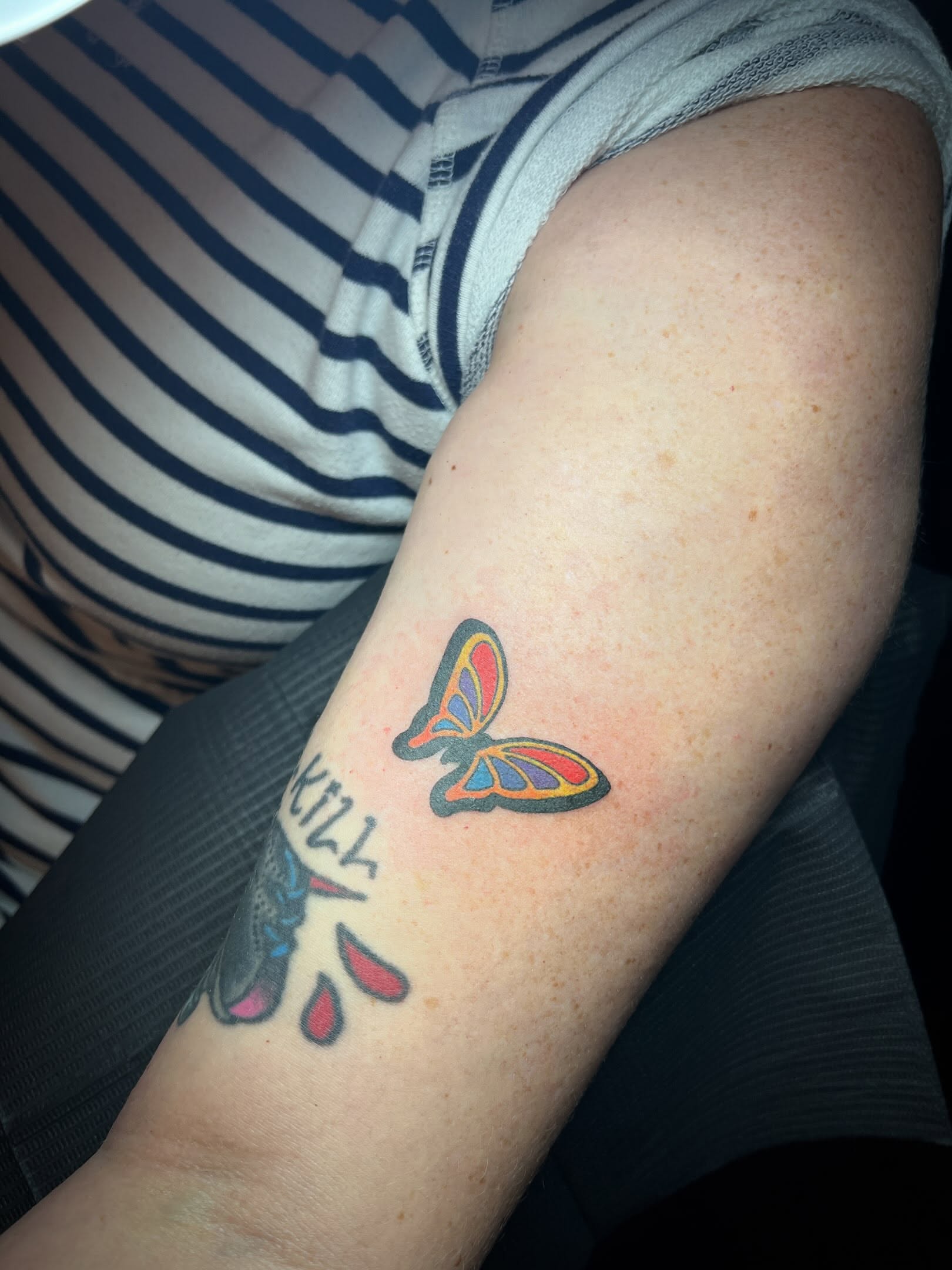 Butterfly new school tattoo on the forearm by Tattoo Kayla