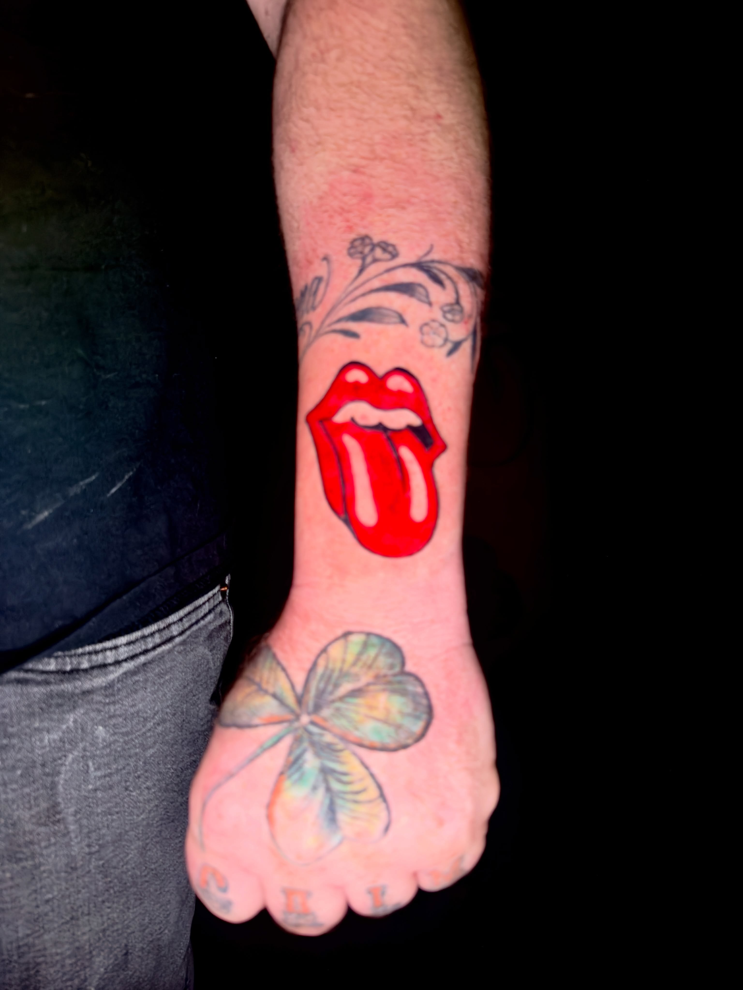 Rolling stones tongue American traditional tattoo on the forearm by Caloy Obra