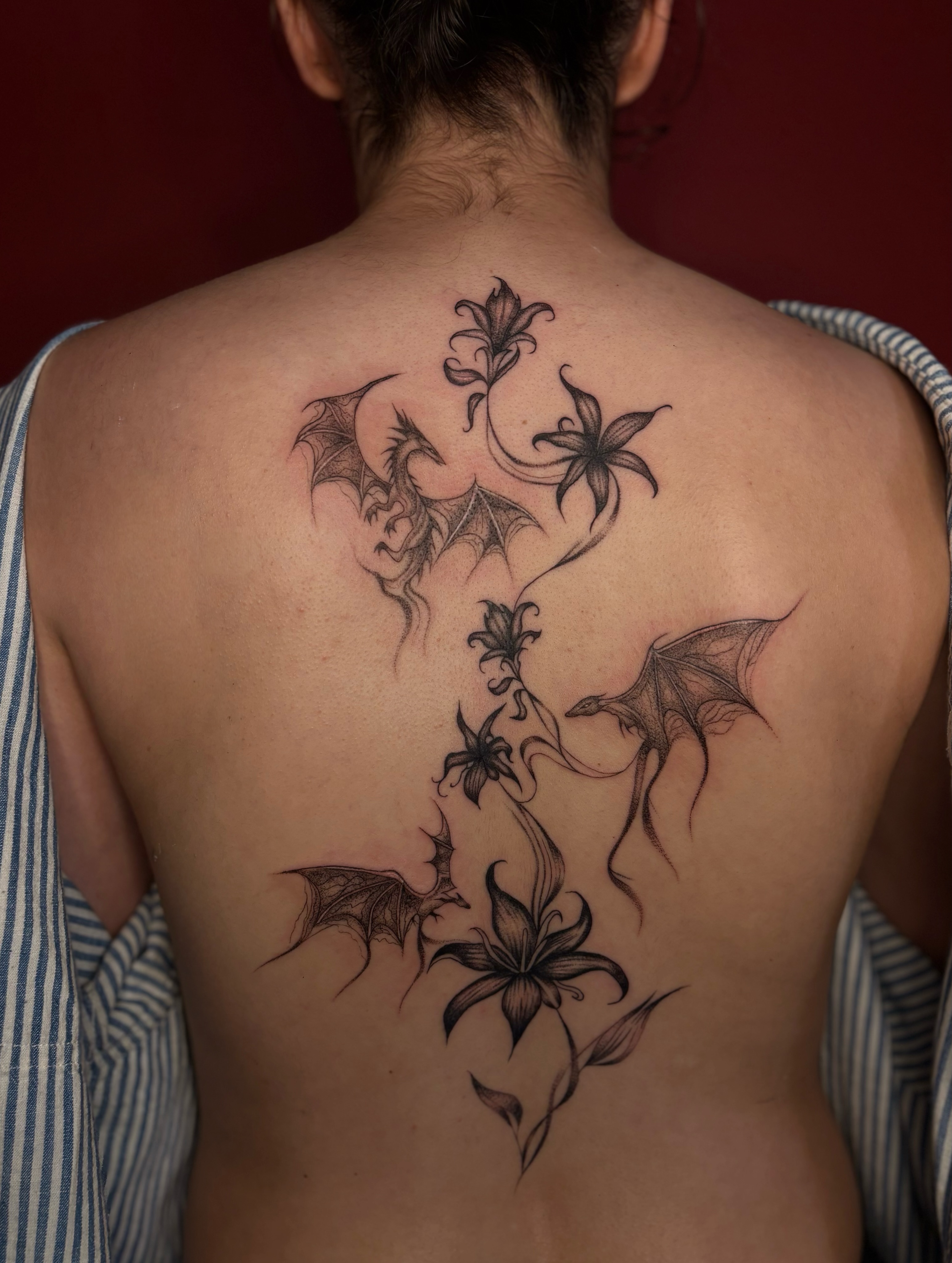Lilies and bats realism tattoo on the back by the ink witch ๐ฎ๐ค๐