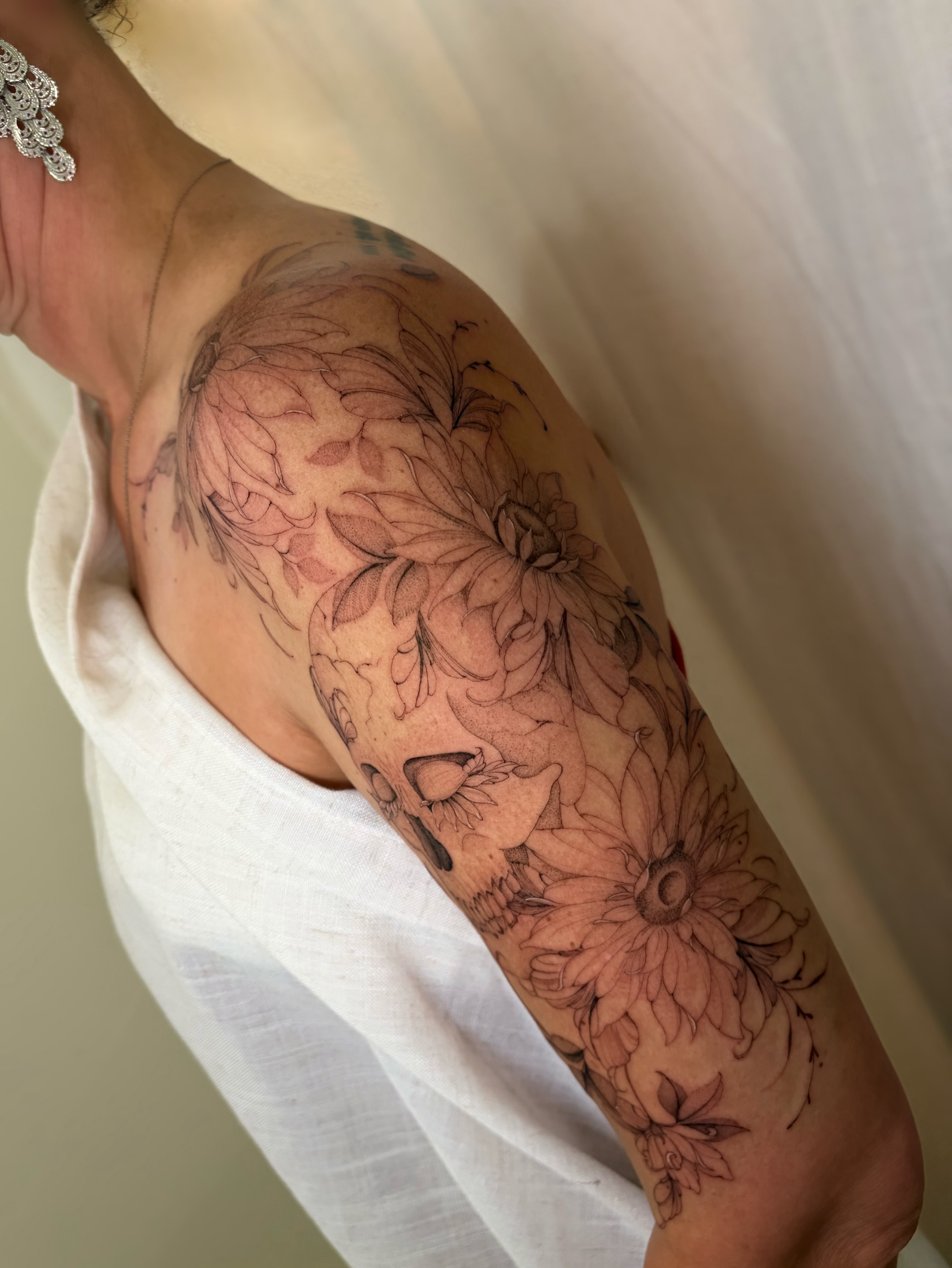 Floral design black and grey tattoo on the upper arm by Justene Renee 🖤 Fine Line Tattoo Artist