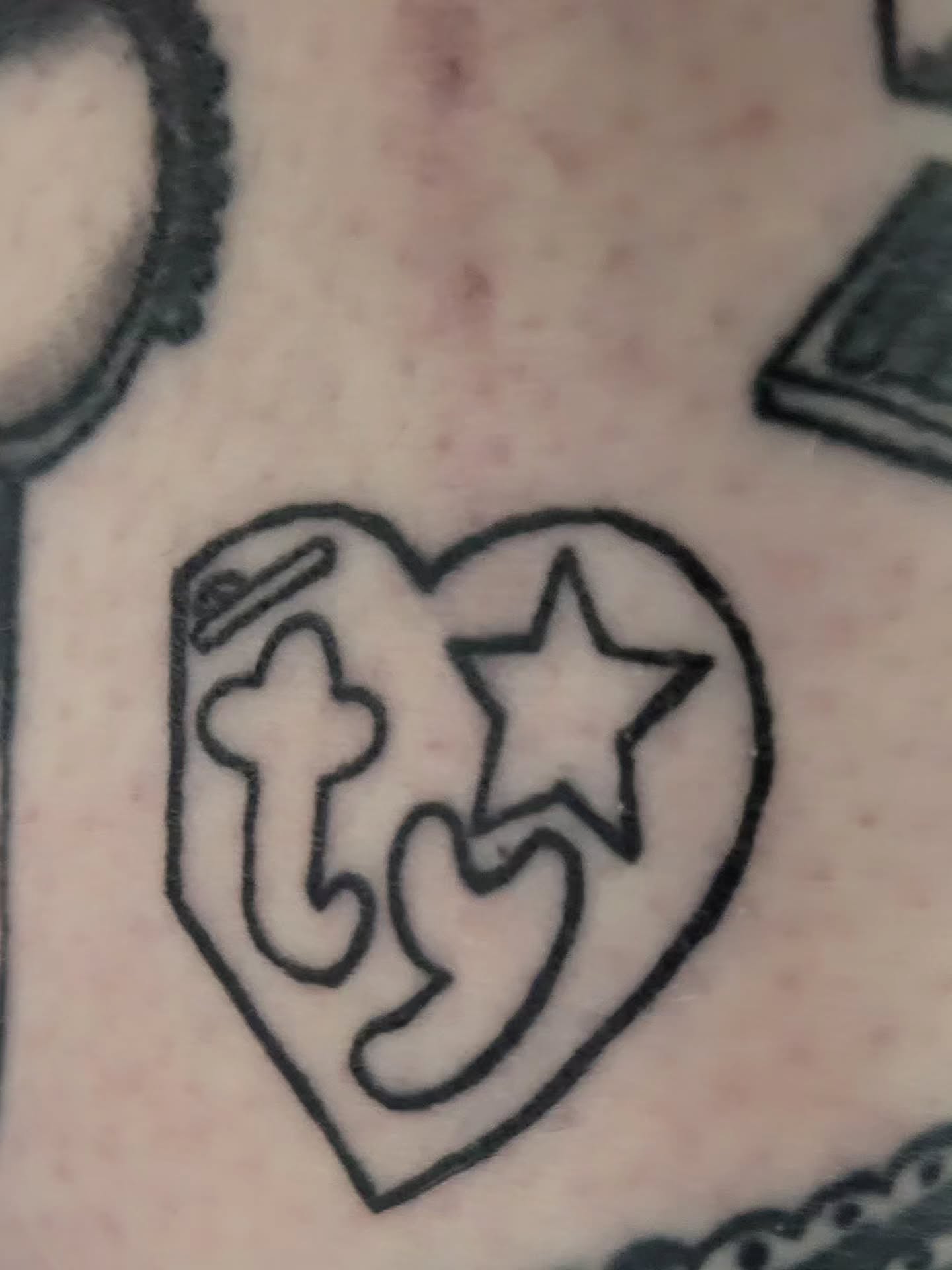 Heart with cross and star black and grey tattoo by Peach & Poke, Lethbridge, Alberta