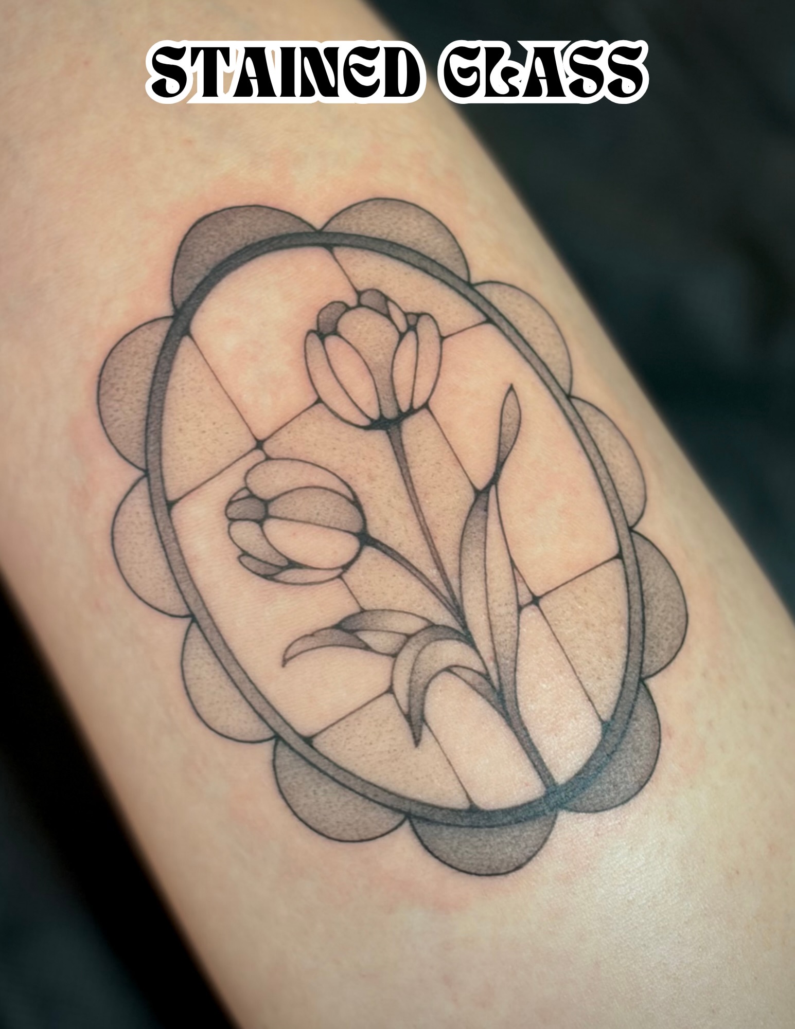 Stained glass tulip geometric tattoo on the forearm by Victoria Lamorte