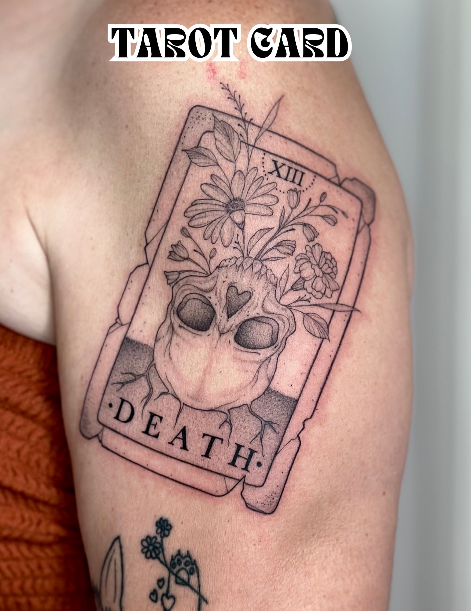 Death tarot card black and grey tattoo on the upper arm by Victoria Lamorte