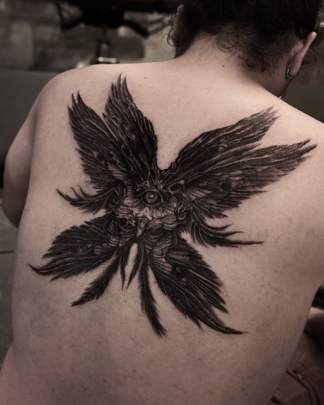 Bird realism tattoo on the back by Gun