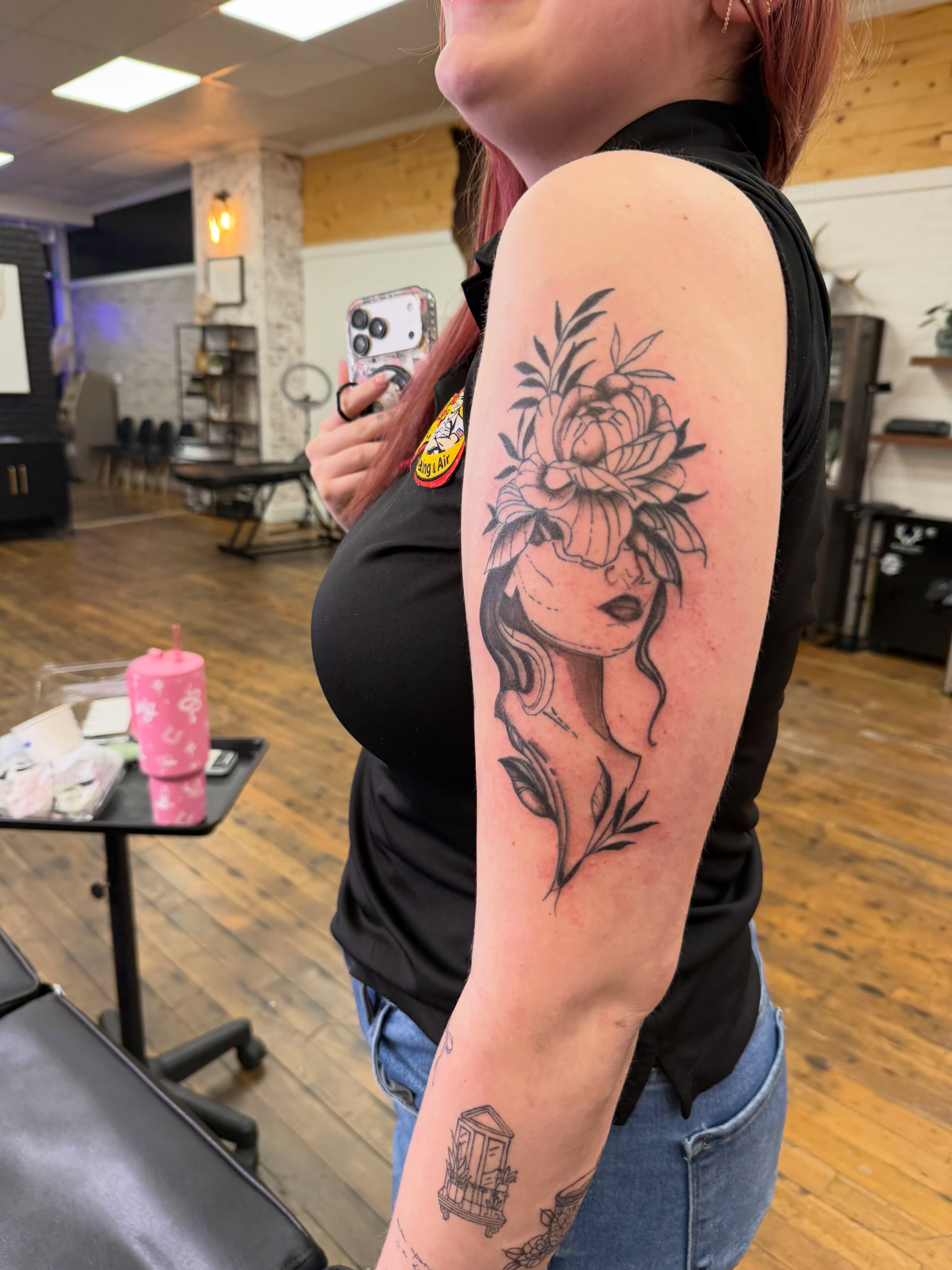 Woman with floral crown realism tattoo on the forearm by Whimsy Ink
