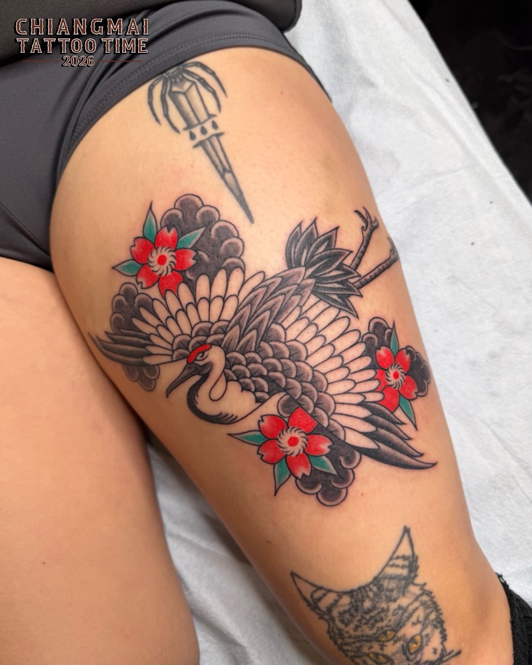Crane and flowers American traditional tattoo on the thigh by Tasha Venola, Bellingham, Washington