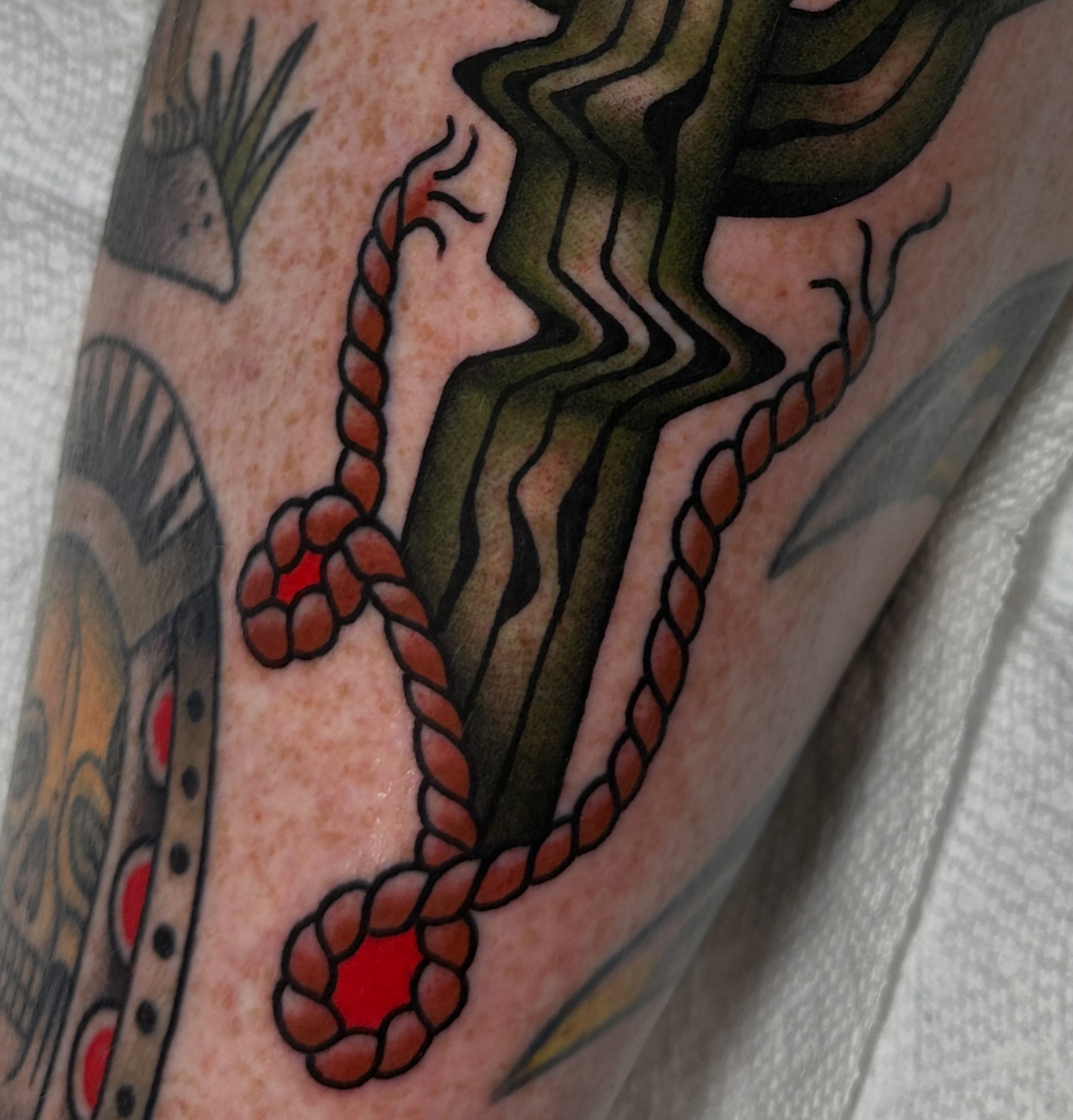 Rope and snake American traditional tattoo on the forearm by Kyle Logan Frary