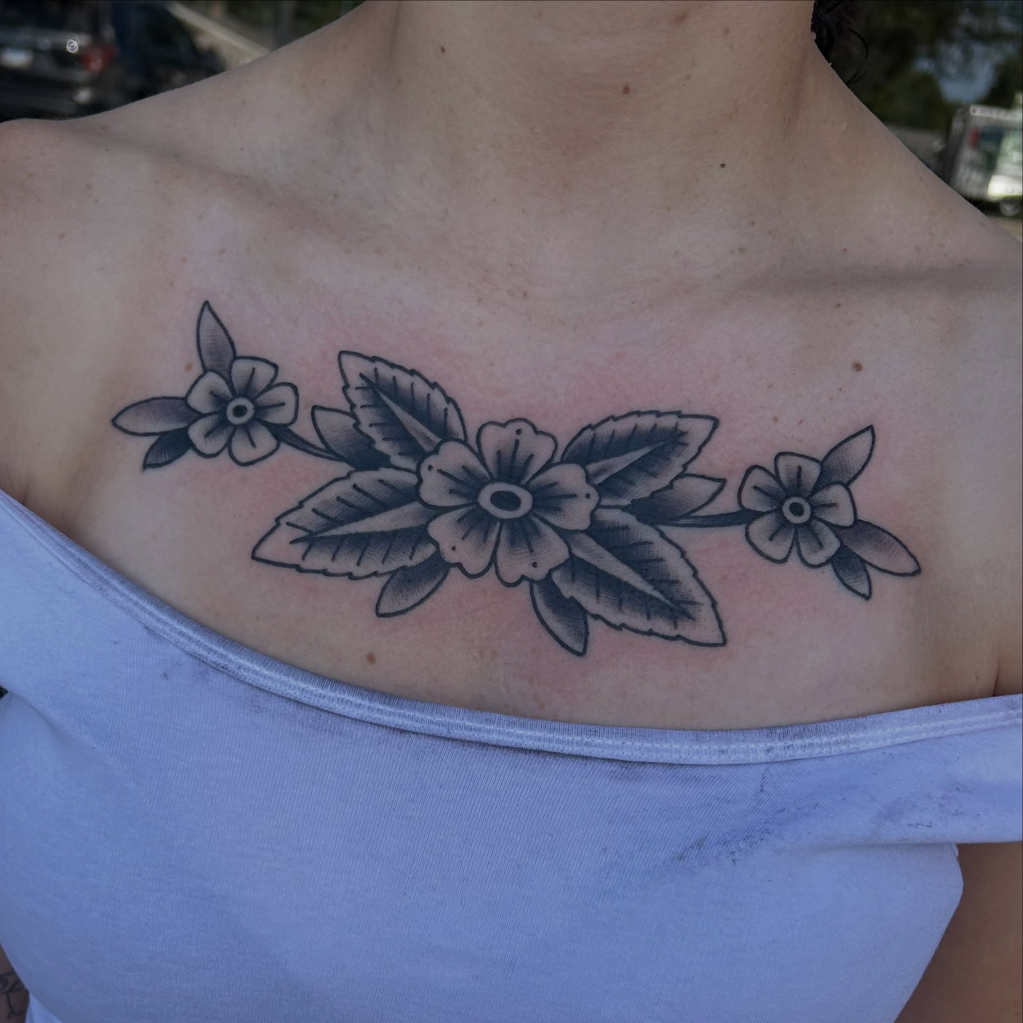 Flower arrangement black and grey tattoo on the chest by 𝕸𝖞𝖆