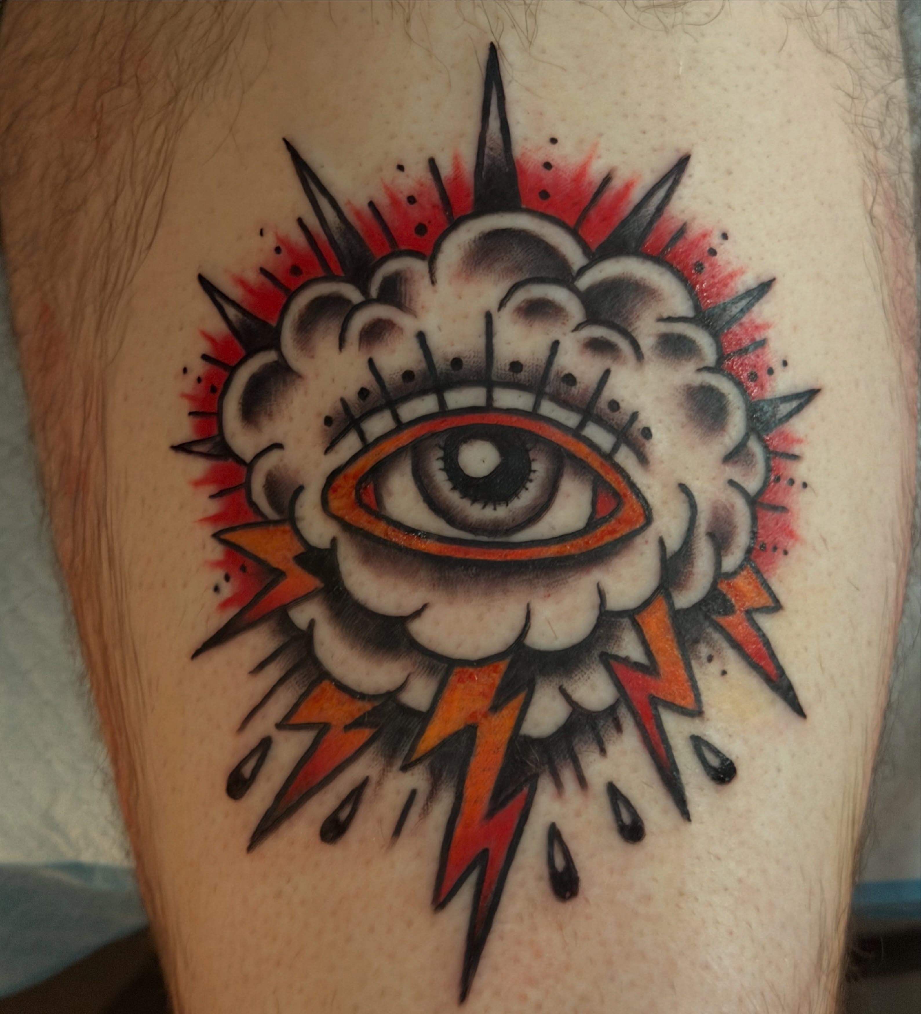 Eye and cloud American traditional tattoo on the thigh by Kelsey Turnis