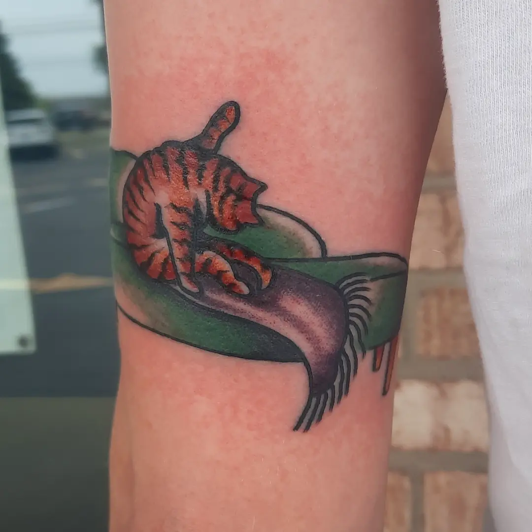 Cat and shoe American traditional tattoo on the forearm by Kaetlyn