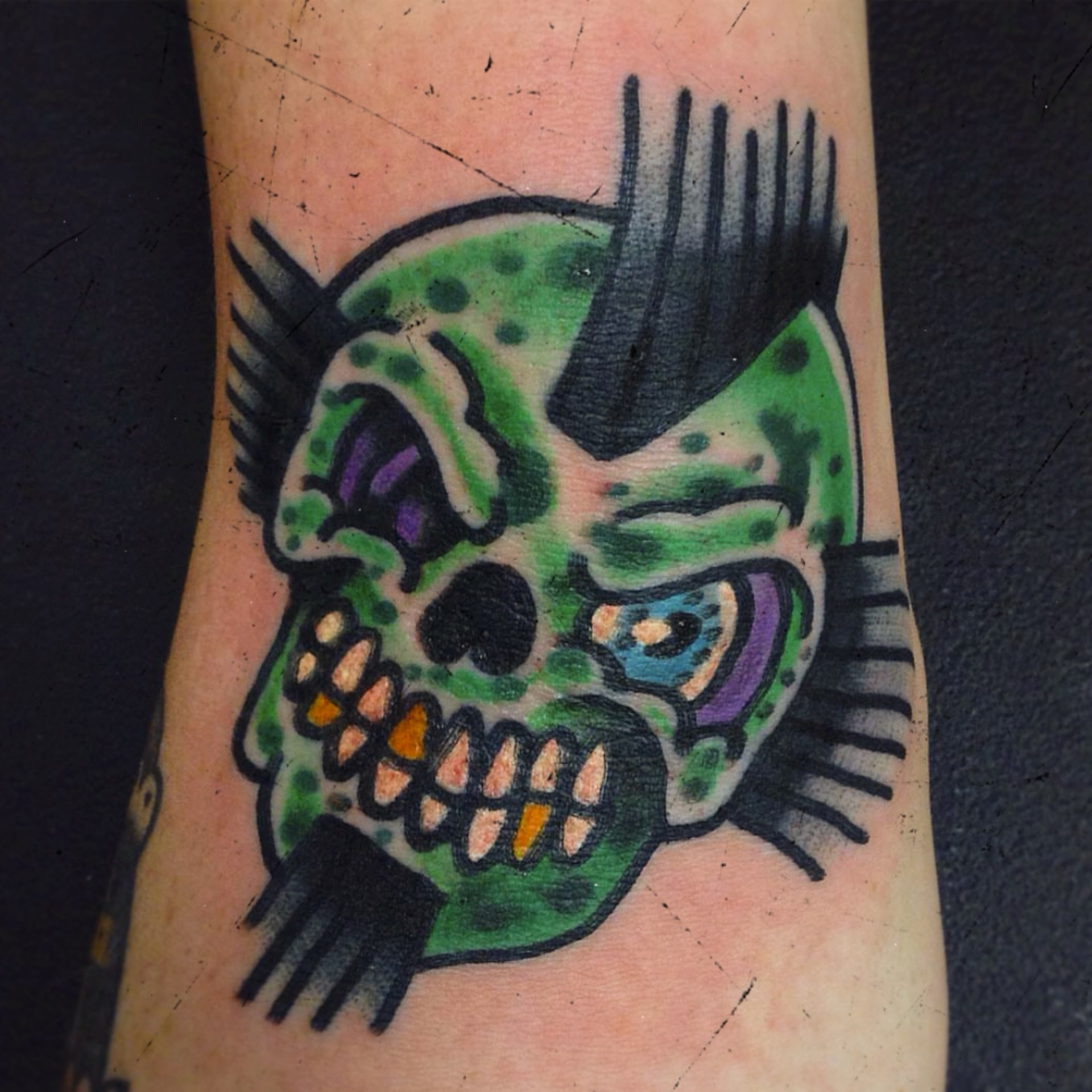 Skull American traditional tattoo on the forearm by Neil Daggers