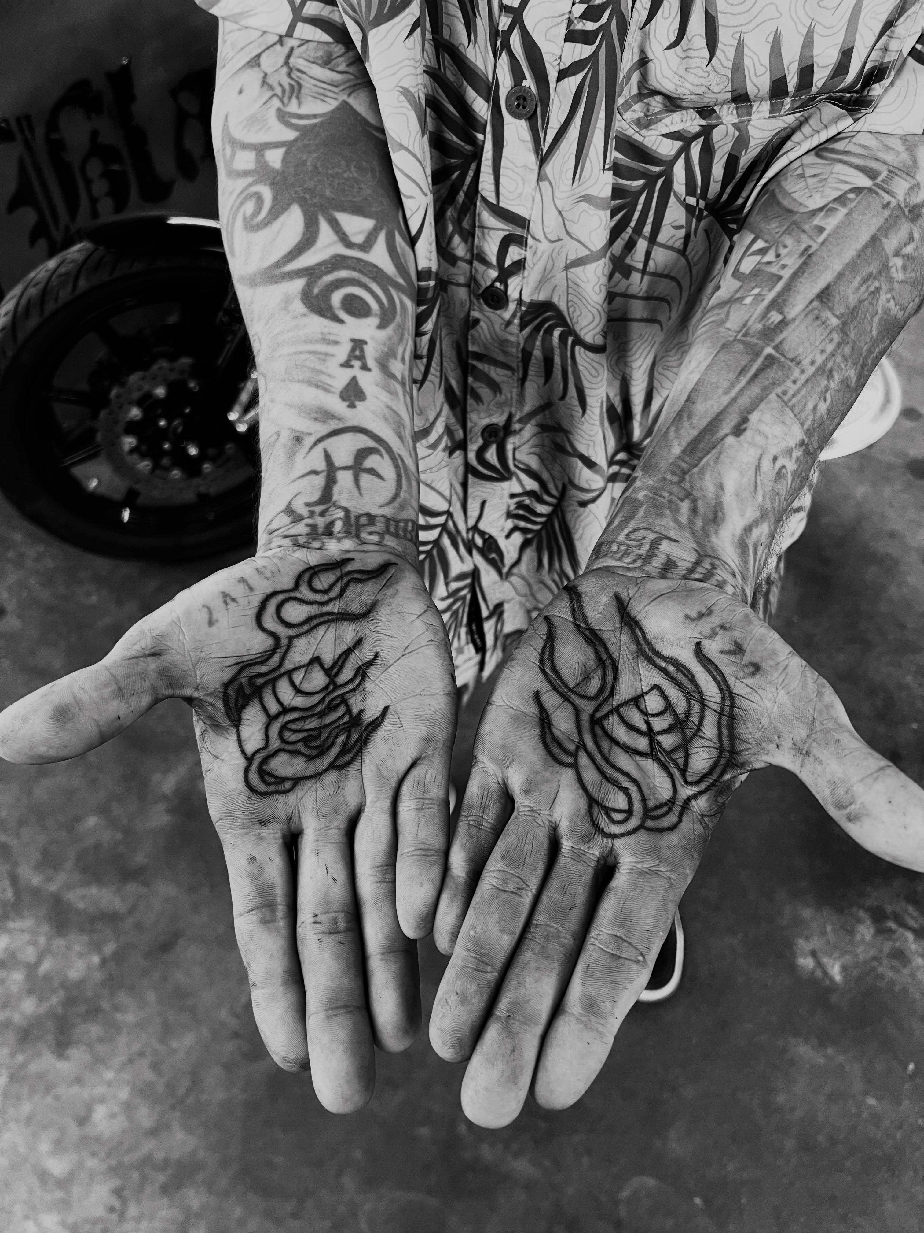 Flame black and grey tattoo on the hand by Dylan O'Quin