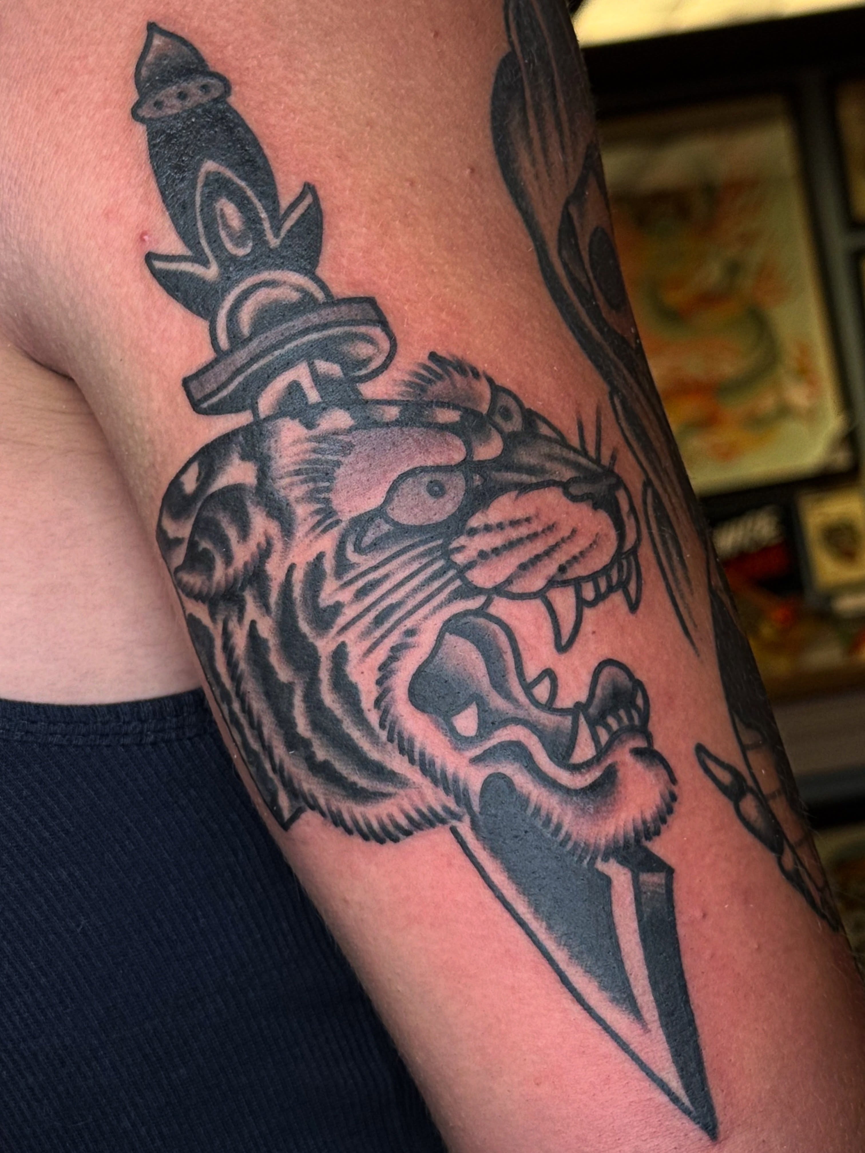 Tiger head with knife American traditional tattoo on the forearm by ๐ฎ๐๐๐๐ ๐ญ๐๐๐๐๐