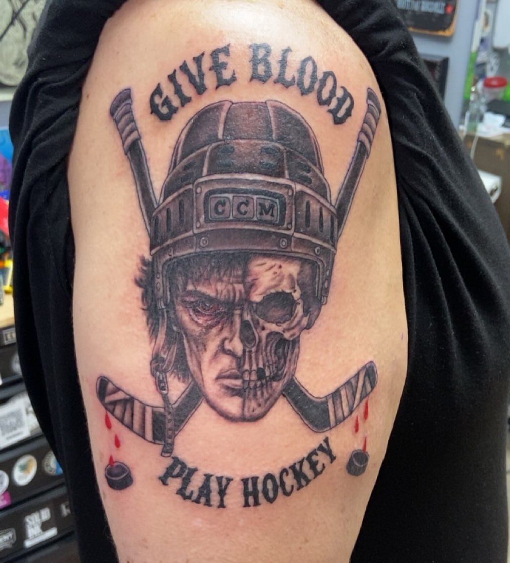 Hockey player skull realism tattoo on the shoulder by Erin McGloin