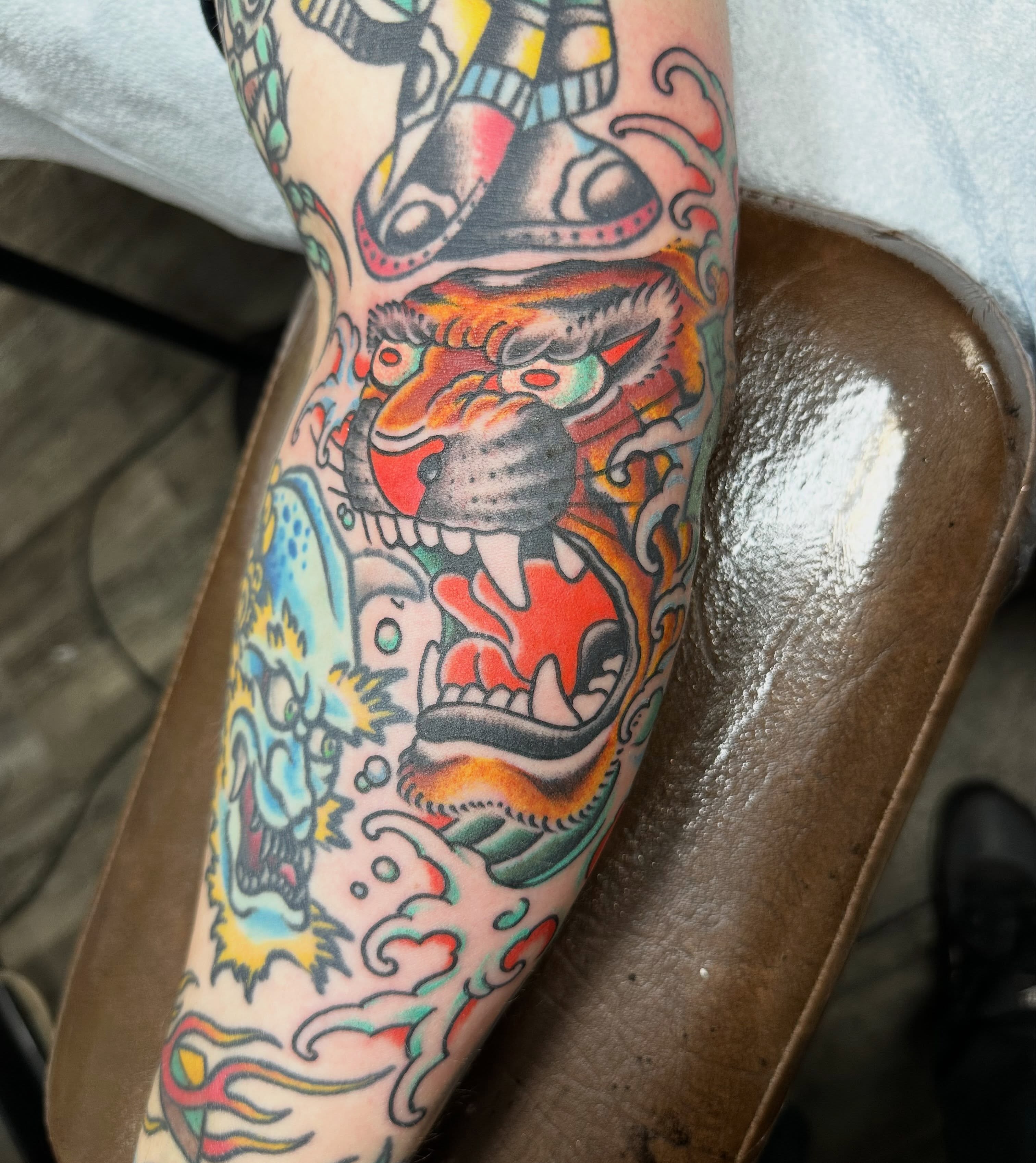 Lion American traditional tattoo on the forearm by Devin Spenny