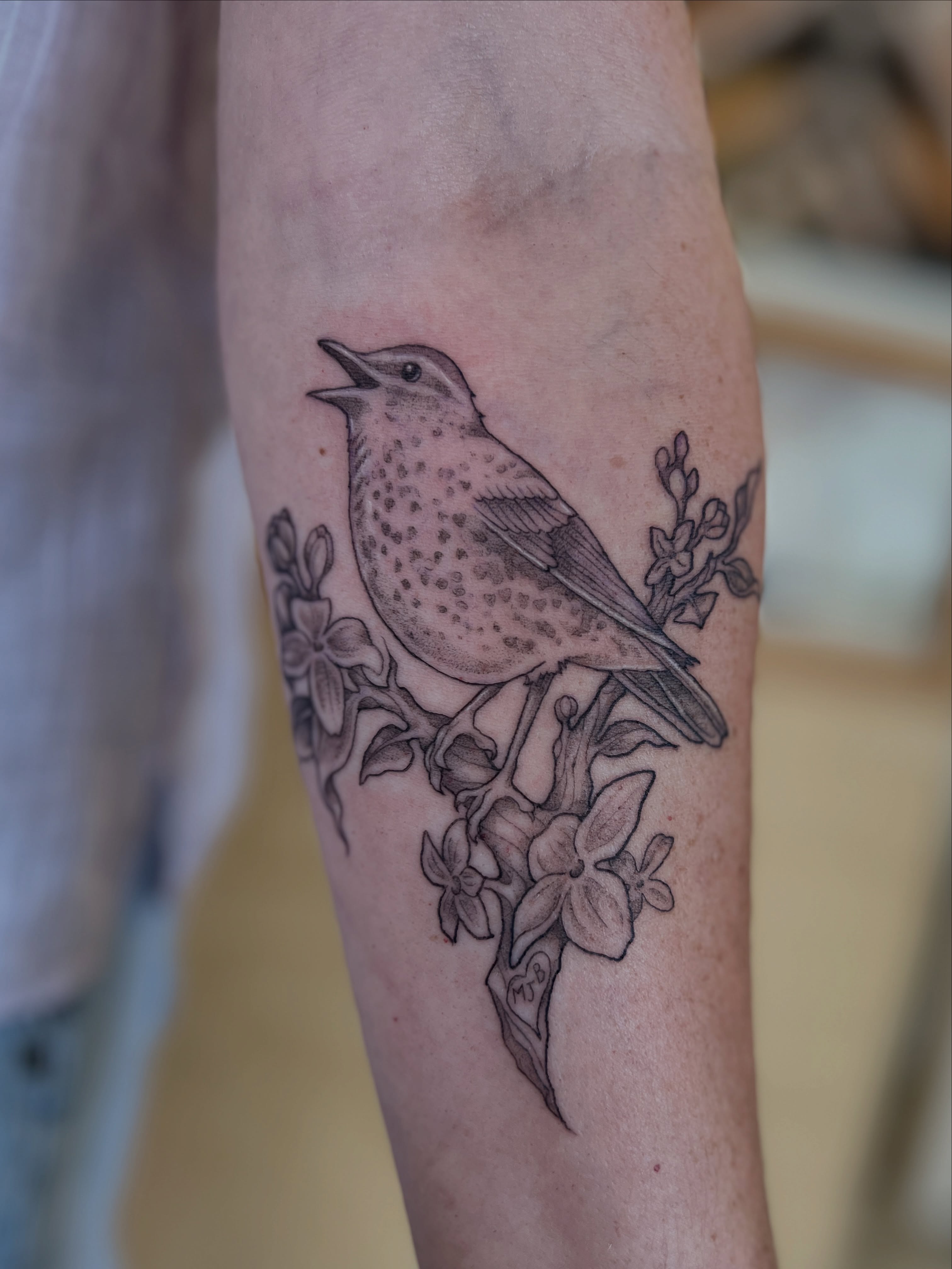 Bird and flowers dotwork tattoo on the forearm by Kelsi Hooper, Seattle, Washington