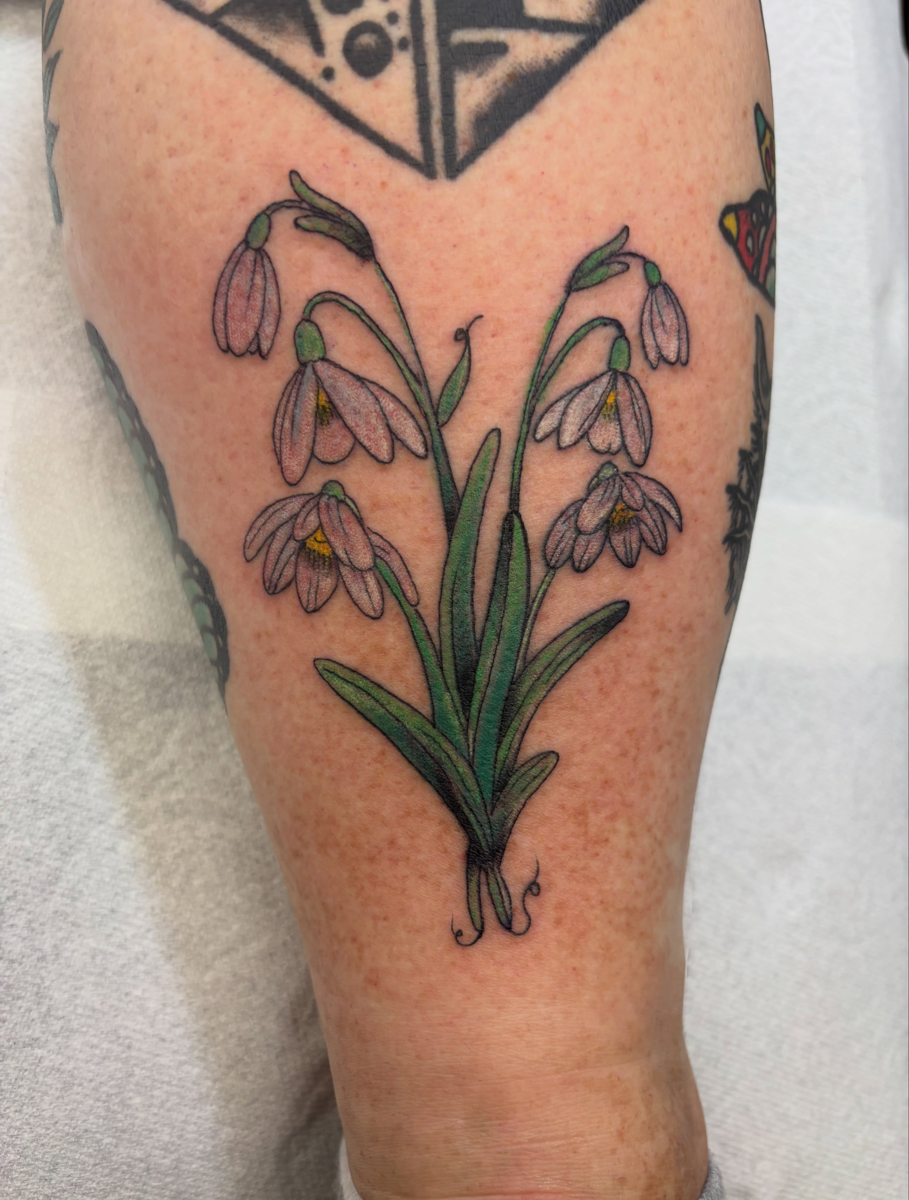 Snowdrops realism tattoo on the forearm by Las Vegas Tattoo Artist